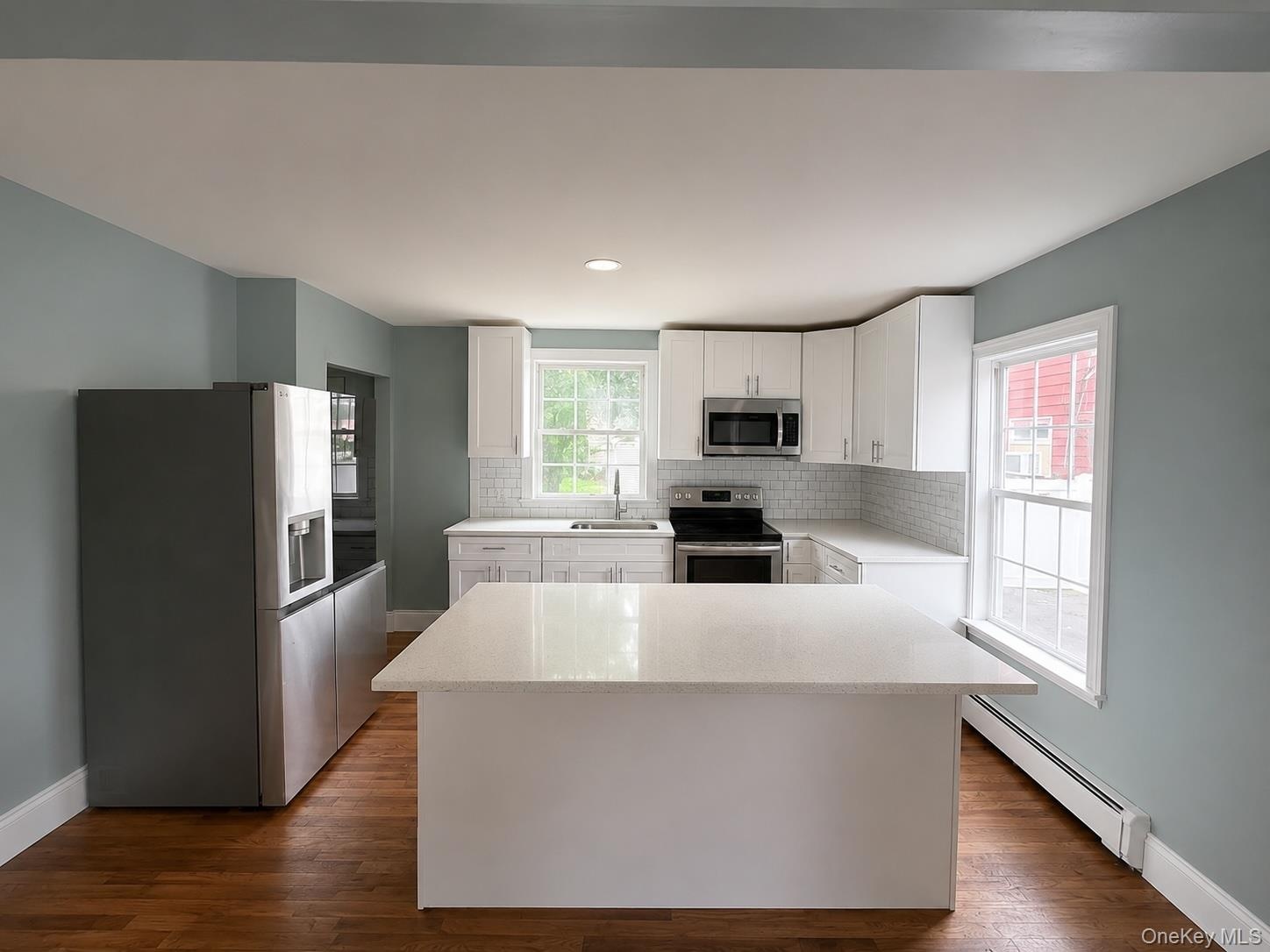 Kitchen with counter top. Access to rear and lower level basement.