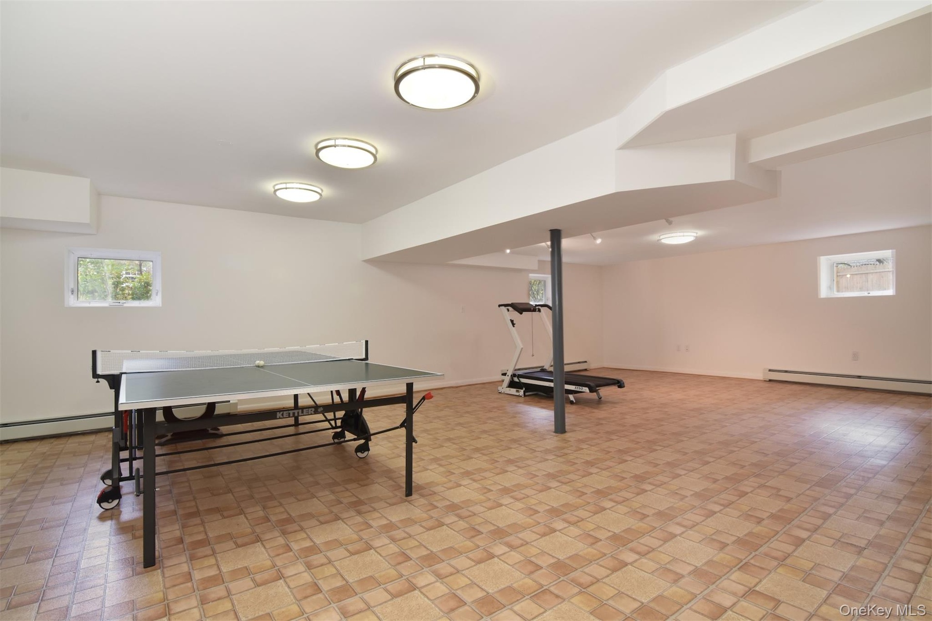 Game room featuring plenty of natural light and baseboard heating