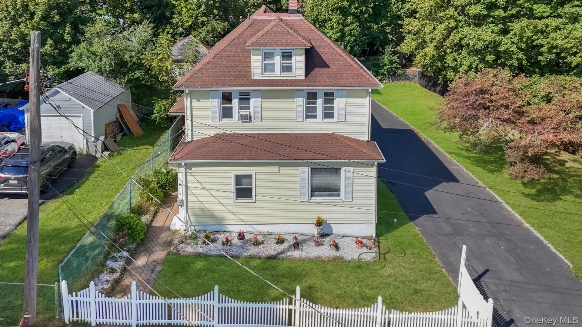 View of front of home featuring a shingled roof and a chimney