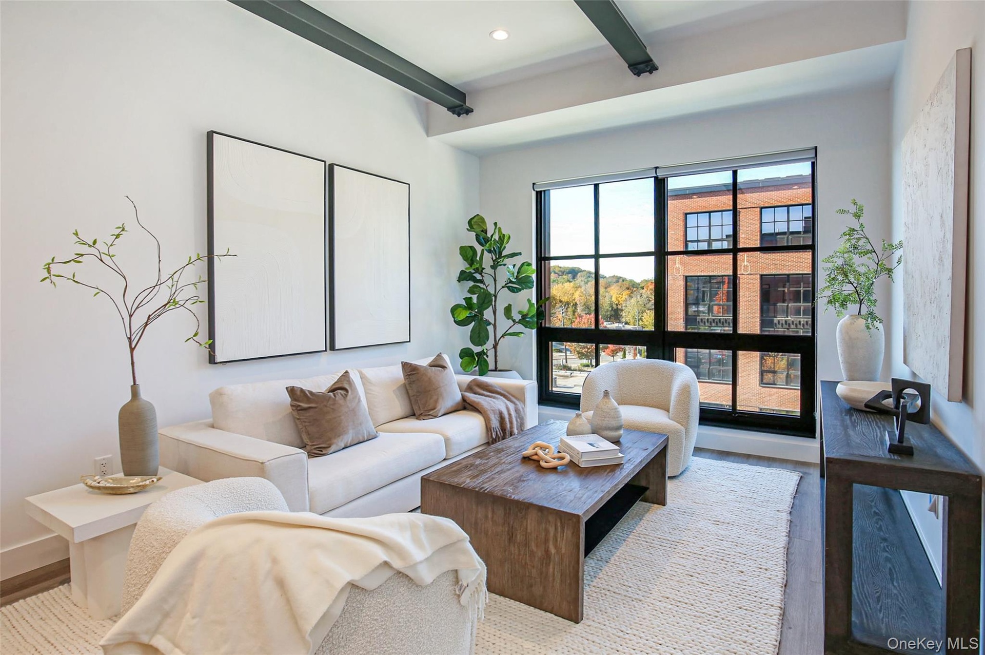 Living area with beam ceiling, wood finished floors, and recessed lighting