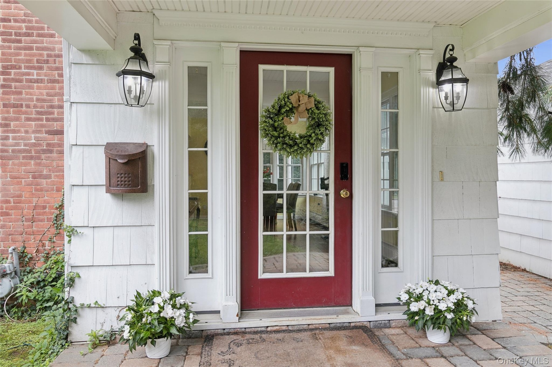 Covered side door entrance with delightful porch overlooks the side/front yard.