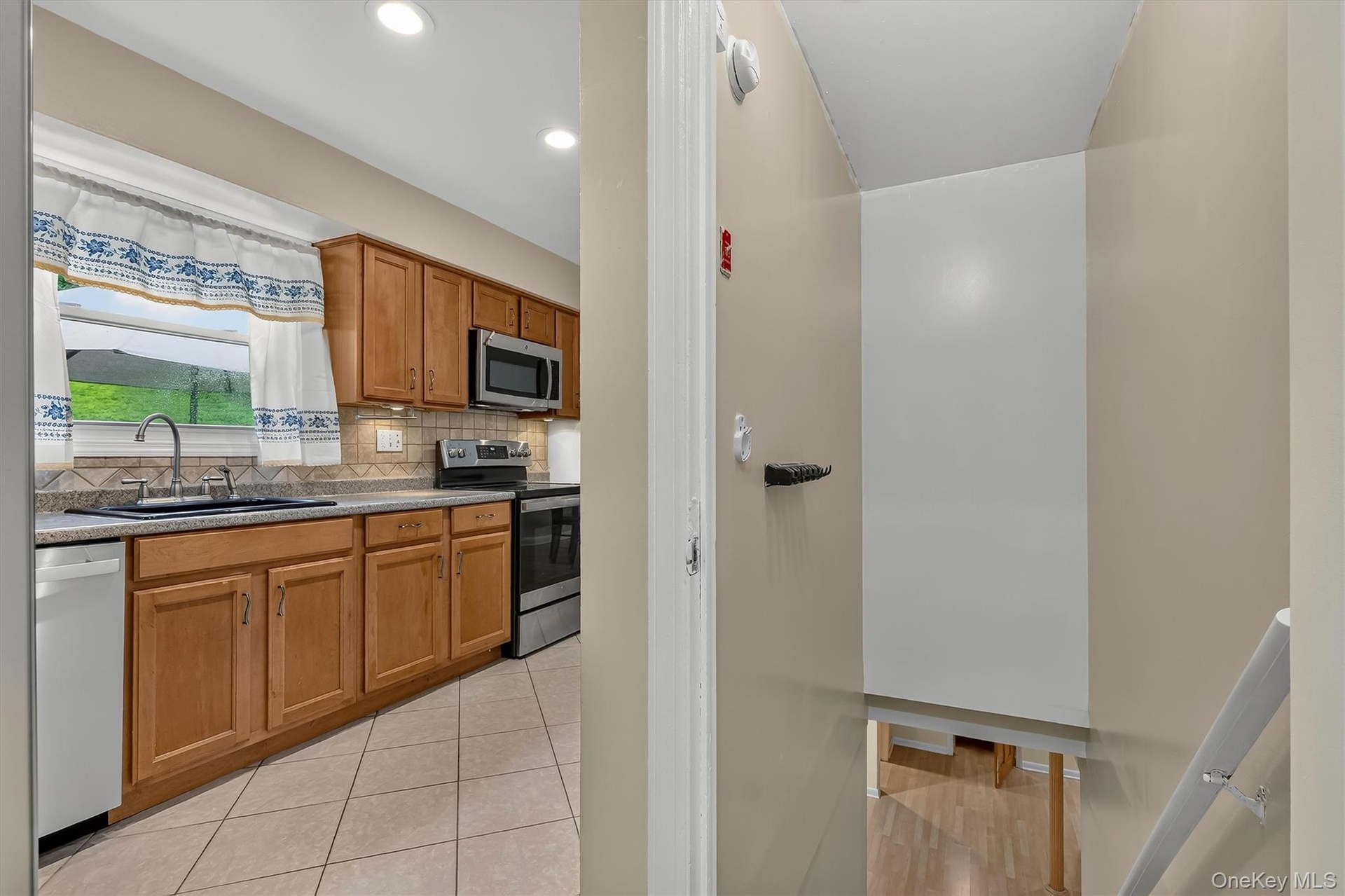 Stairway off the kitchen leads to the spacious lower-level family room and additional living space.