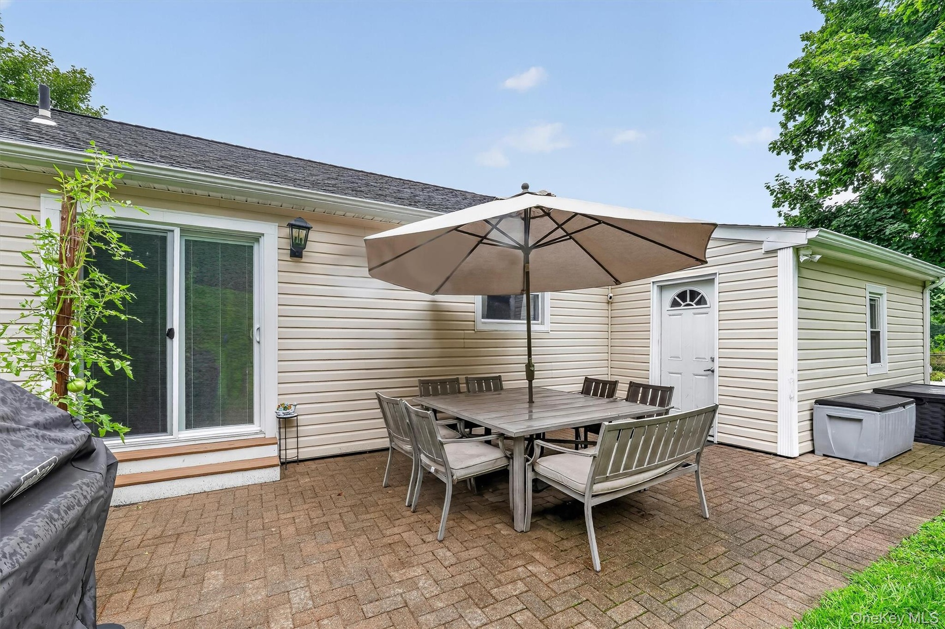 Private backyard with patio, perfect for outdoor dining, relaxing, and entertaining.