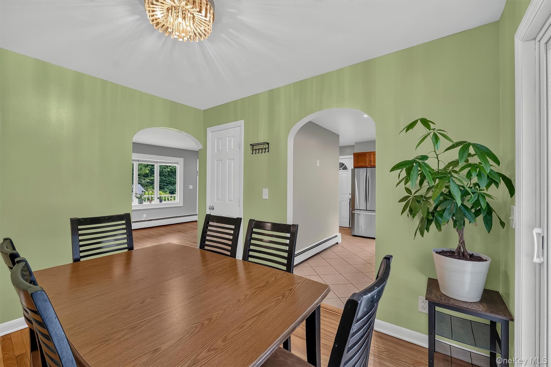 Bright dining room offers a comfortable setting for meals with an open view into the kitchen.