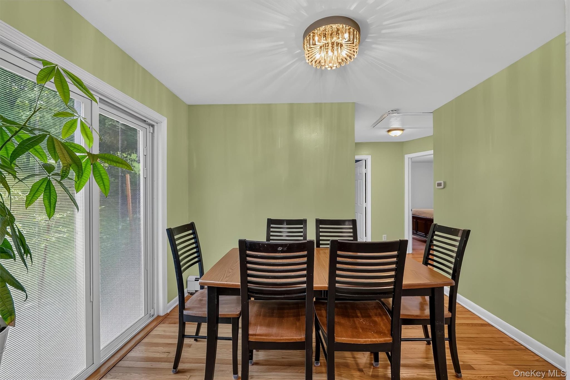 Dining room provides a welcoming gathering space with a view toward the hallway leading to the bedrooms.