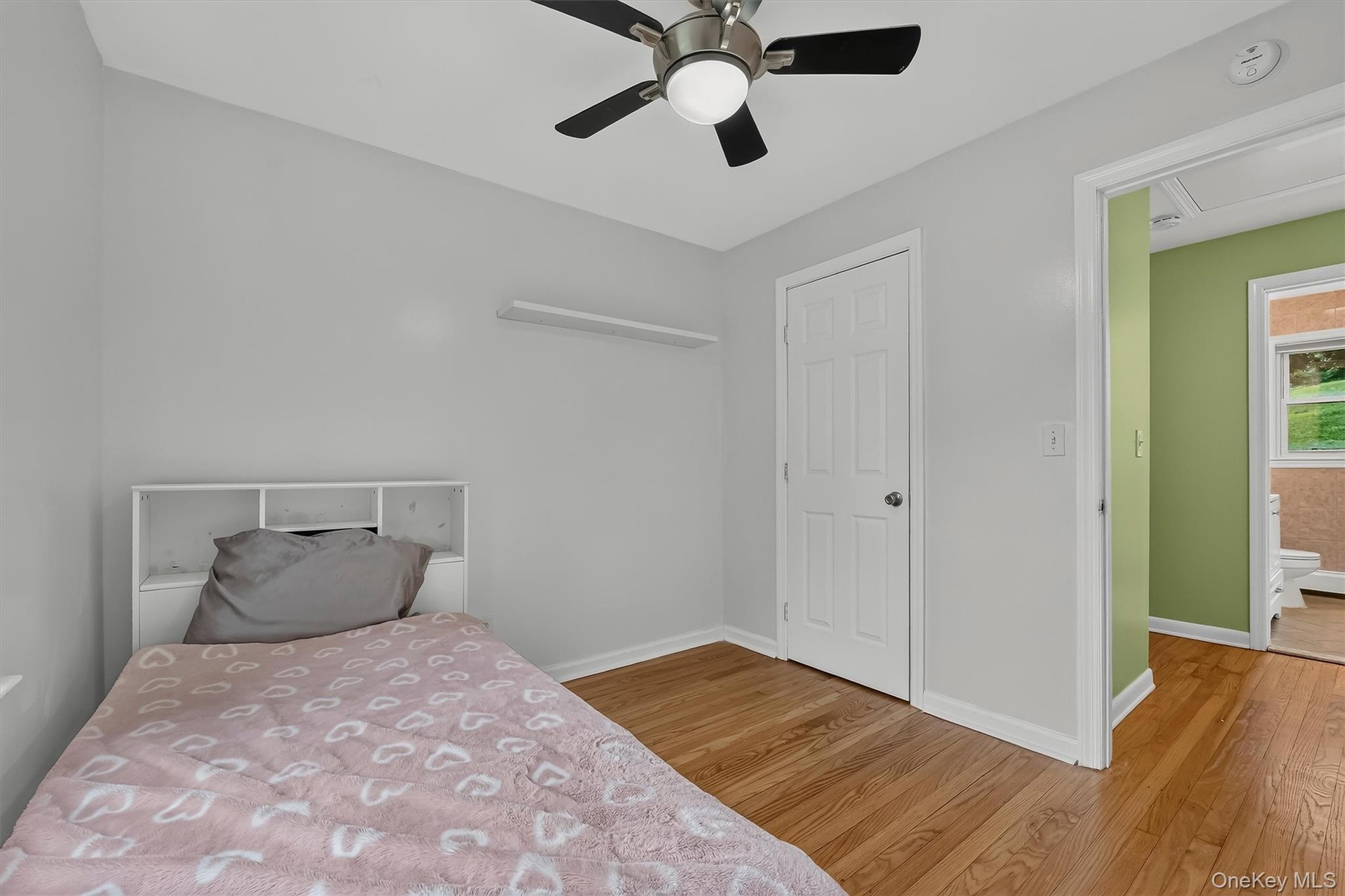 Bright and inviting second bedroom with view into the hallway.