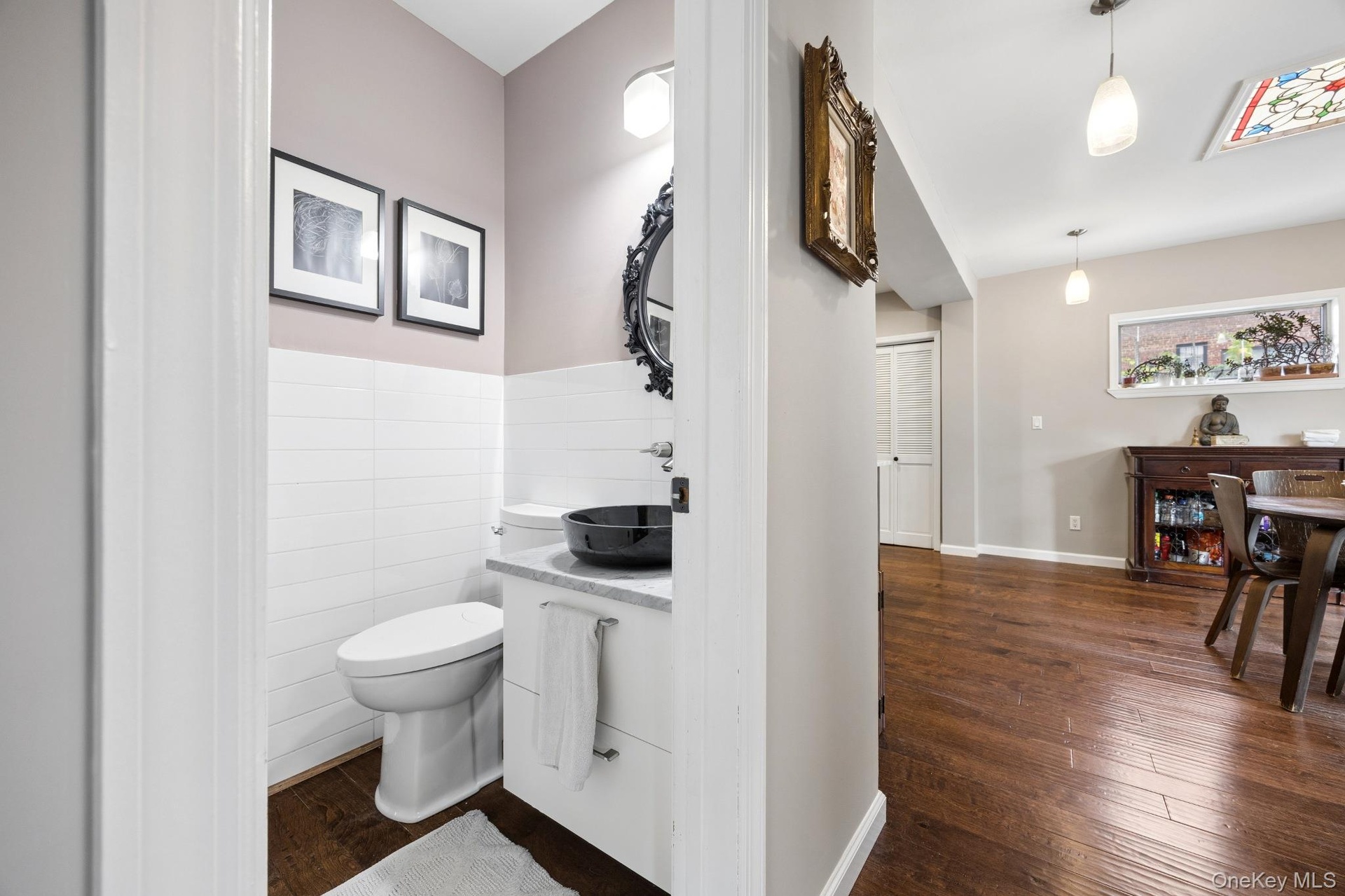 Beautifully appointed powder room showcasing a sleek vessel sink vanity, elegant finishes, and a bright, modern design. A tasteful blend of style and 