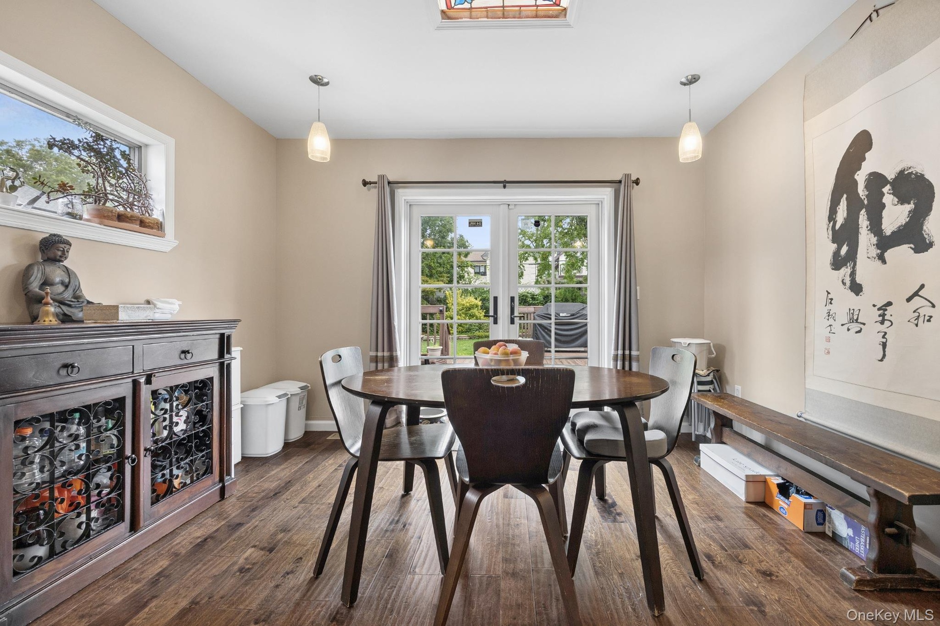 Eat-In Kitchen – Bright and inviting dining area seamlessly connected to the gourmet kitchen, featuring hardwood flooring, stylish pendant lighting, a