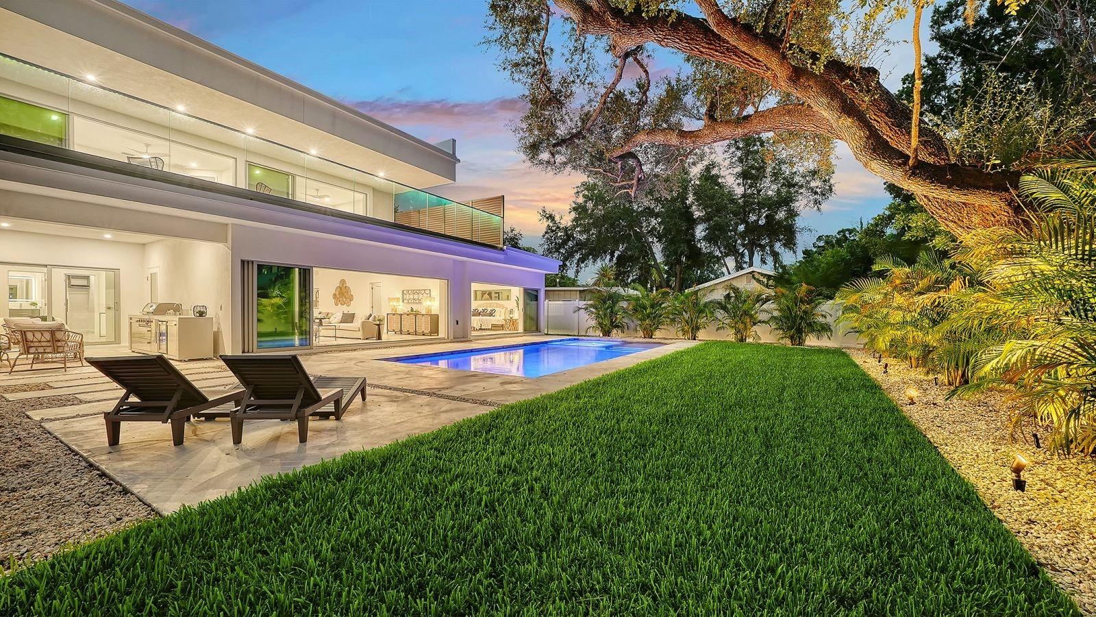 Private backyard with pool and lush landscaping