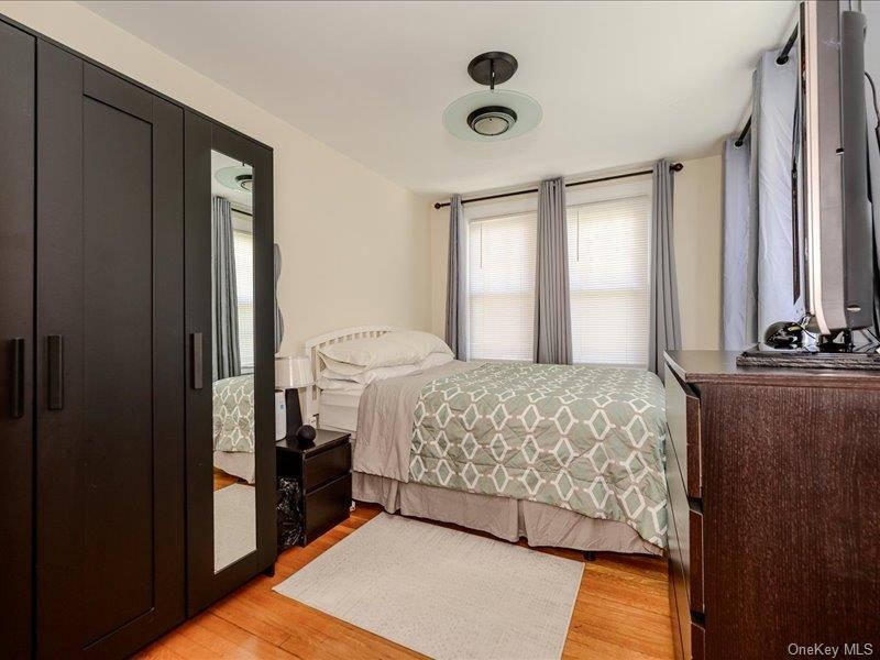 Bedroom # 3 Warm wood flooring complementing a crisp white wall palette