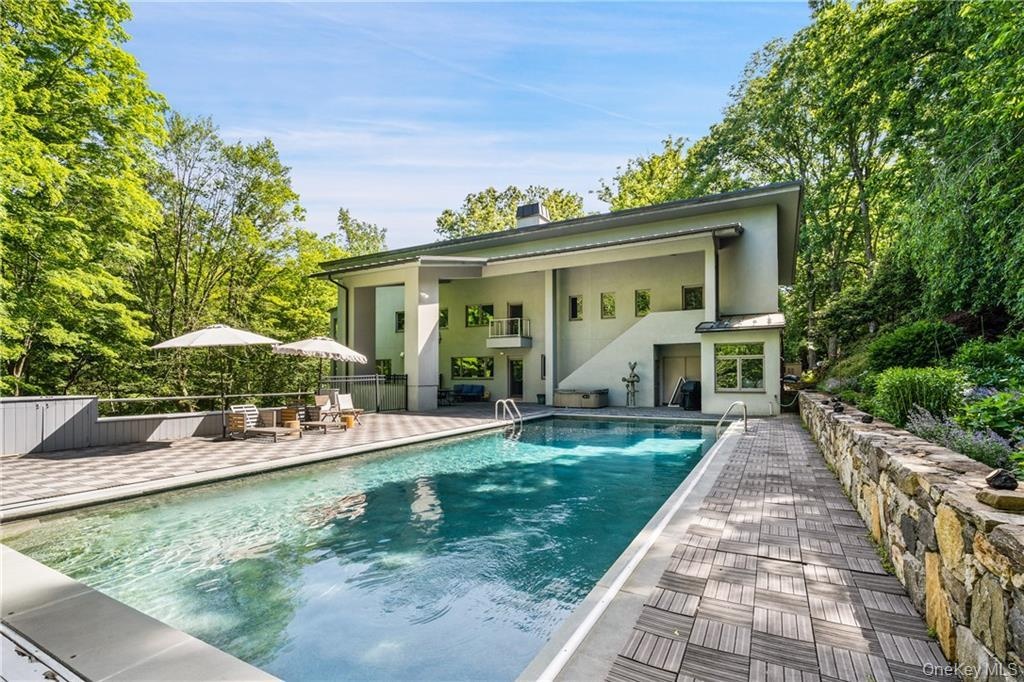 Back of property with a patio, stucco siding, and a chimney