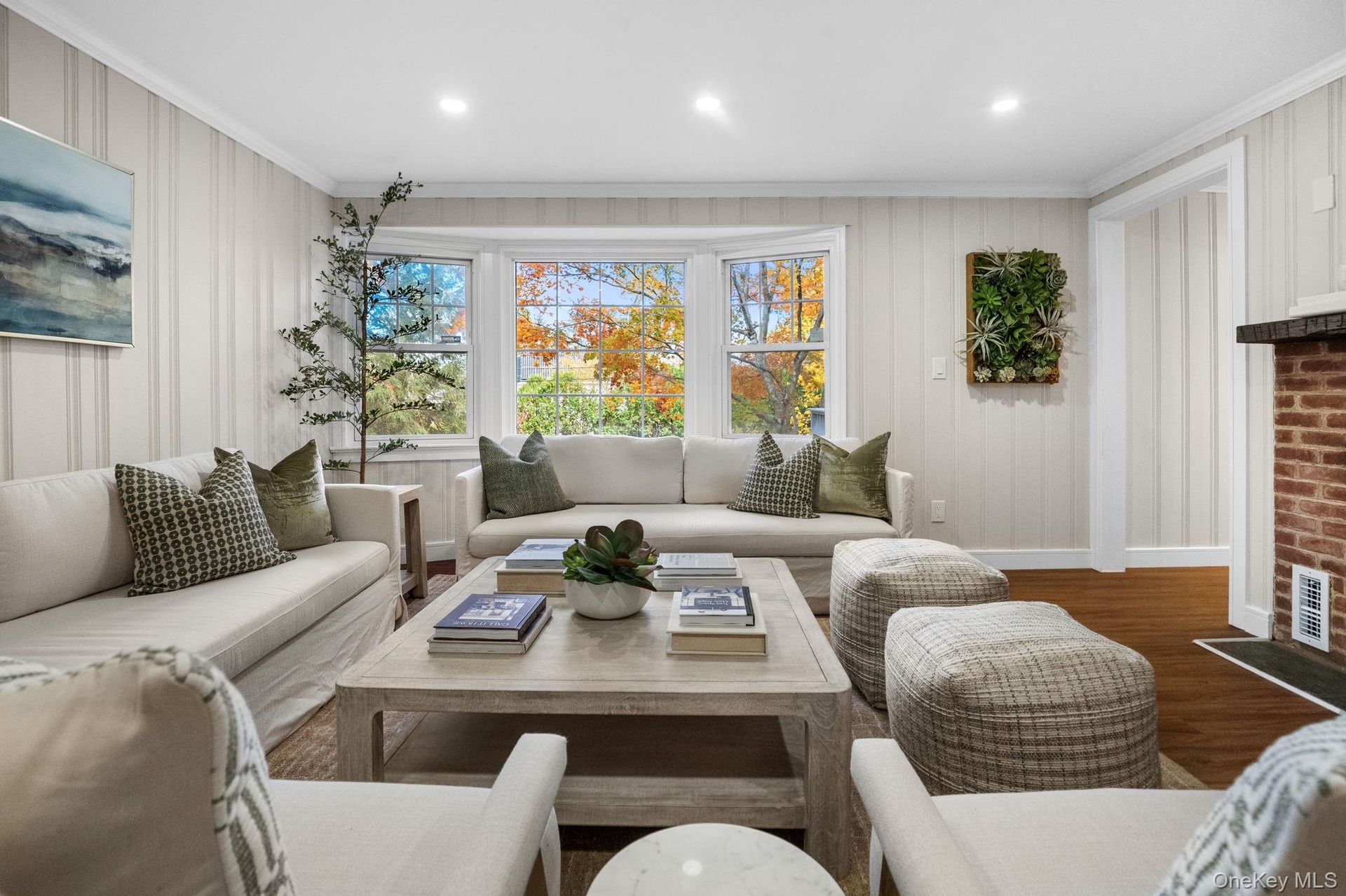 Newly renovated living room featuring a large bay window that fills the space with natural light for an inviting, relaxed atmosphere.