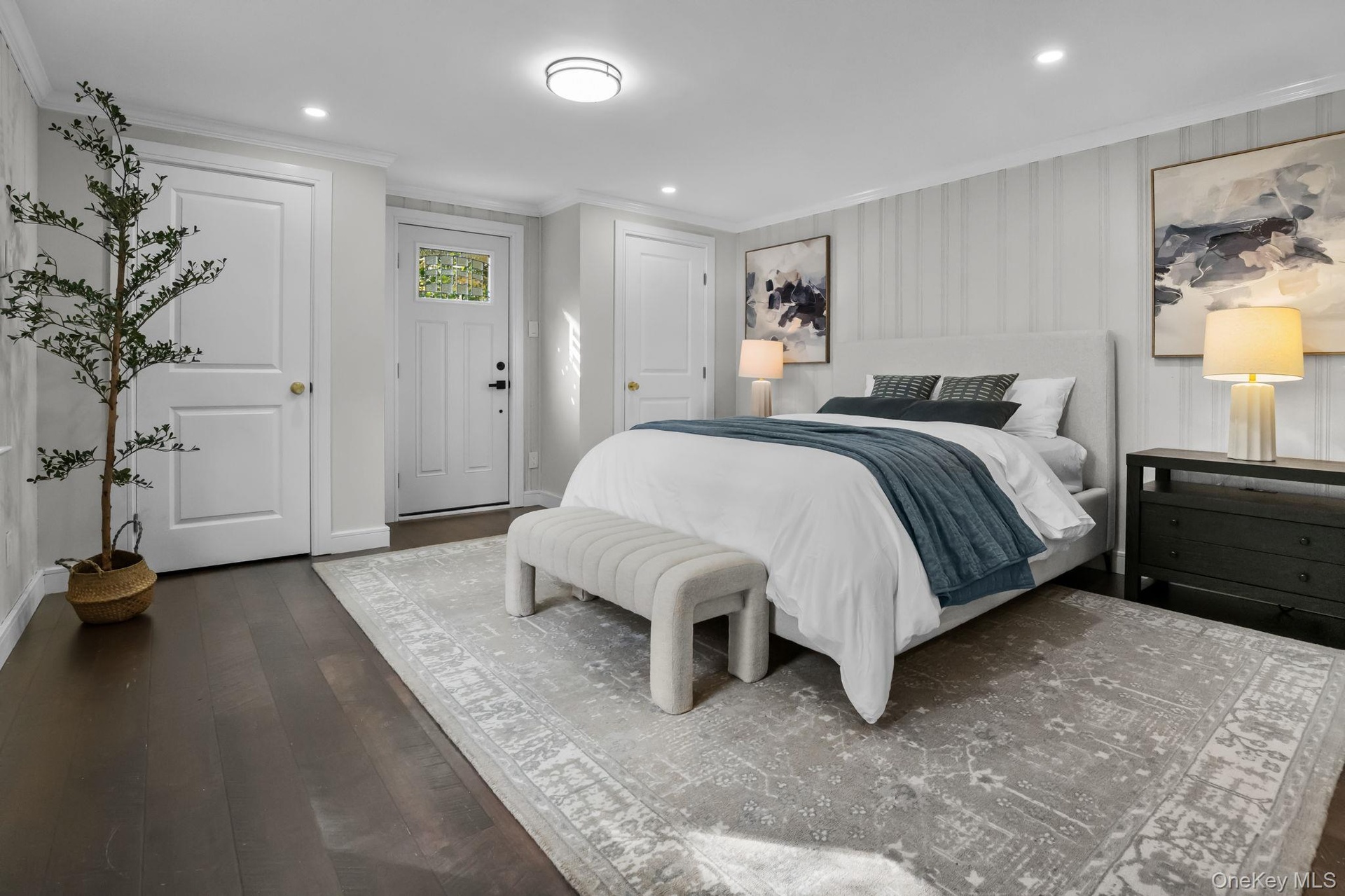 Primary bedroom with private exterior entrance offering convenient access to the yard and outdoor living space.