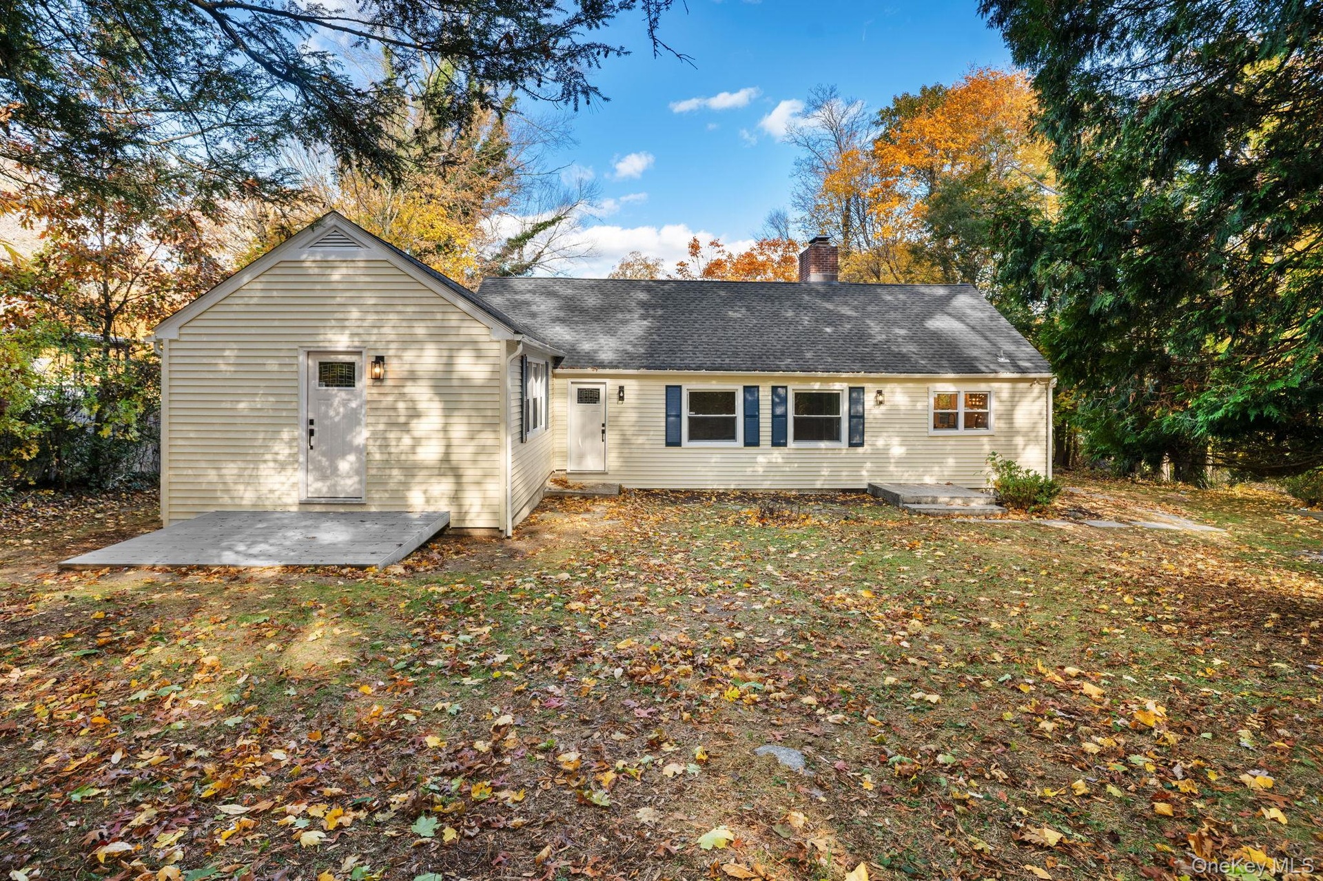 Beautifully maintained exterior with new siding and crisp trim details, showcasing a private backyard perfect for gatherings or quiet evenings at home