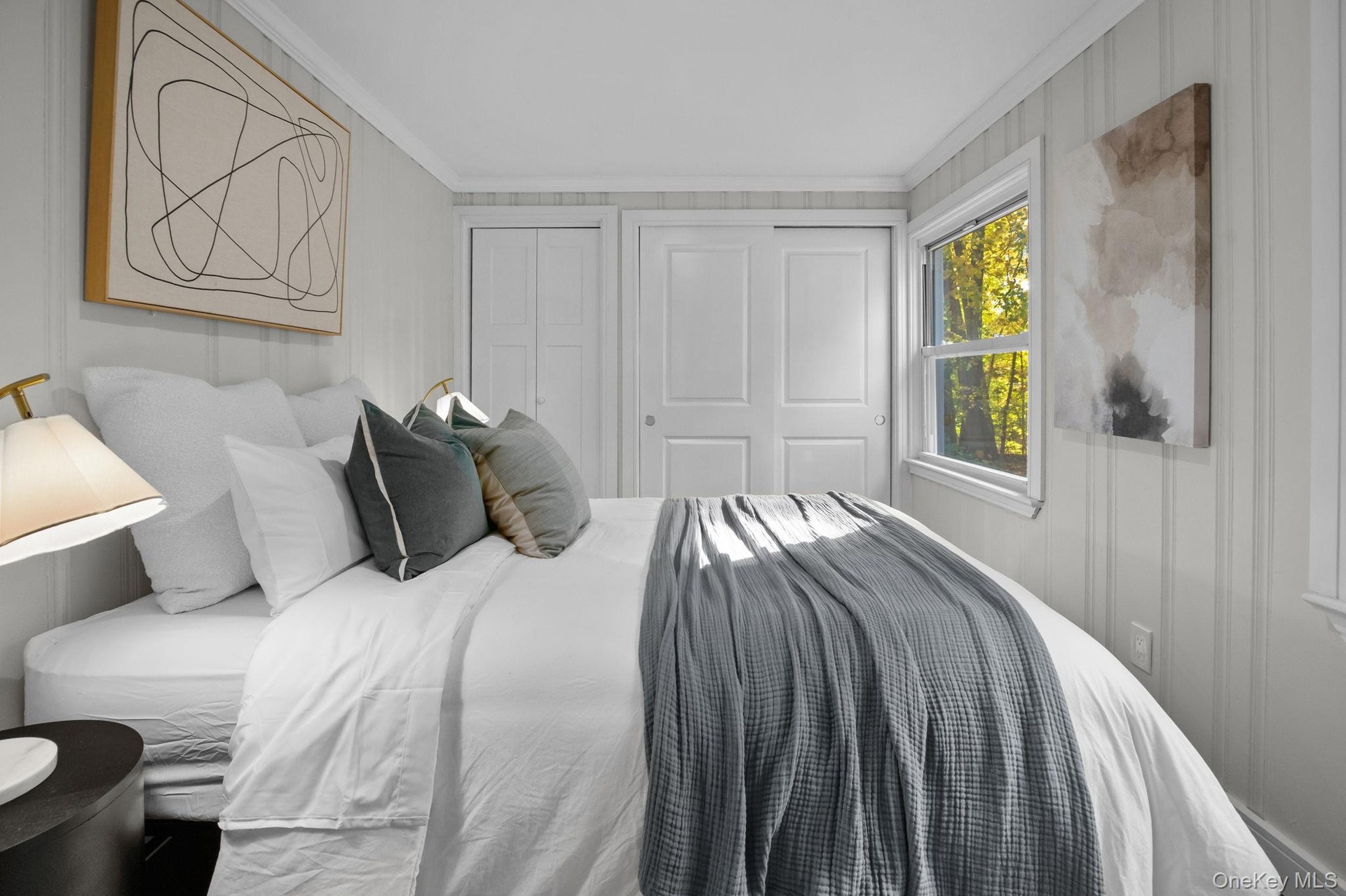 Bright third bedroom with fresh finishes and generous closet space, offering a comfortable setting for rest or relaxation.