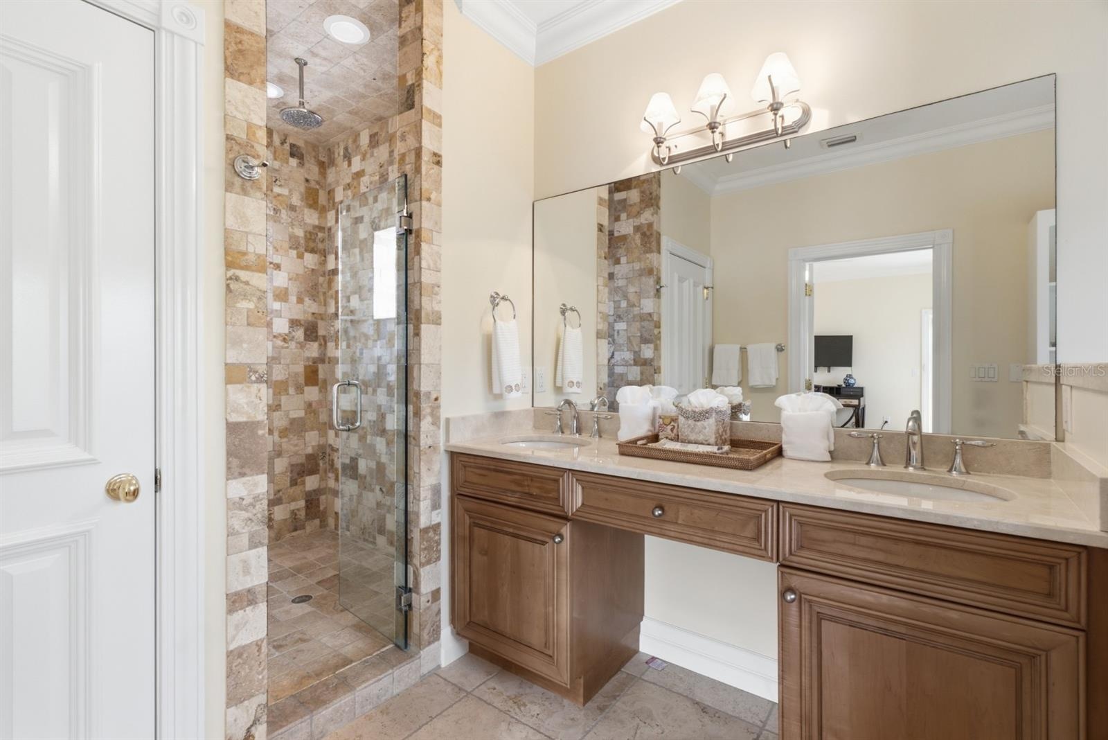 Custom stonework in the large walk in shower with dual shower heads