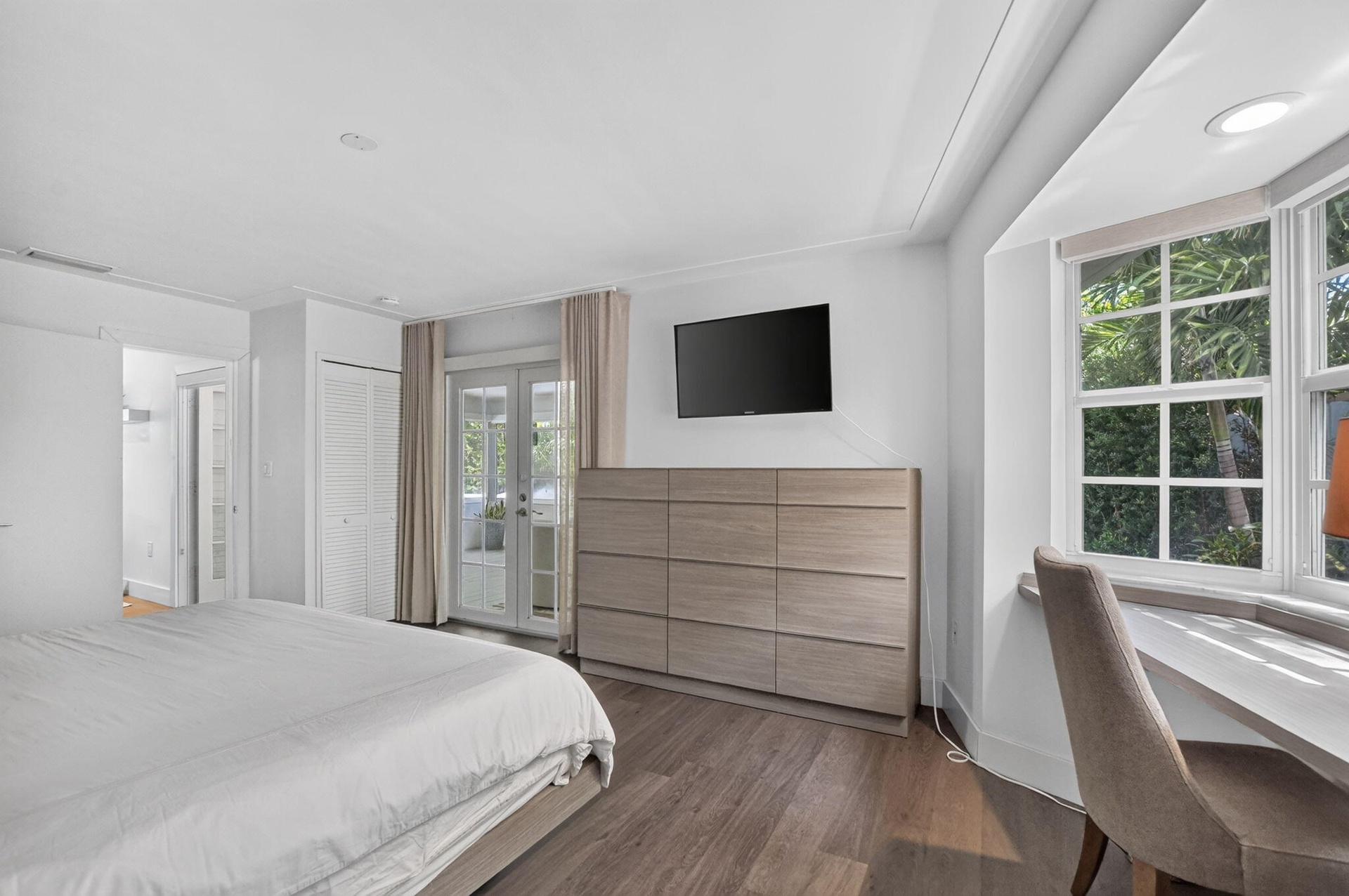 PRIMARY BEDROOM: .. YES! in case you were wondering .. Private French doors open up to the calming spaces aka Sunroom.
