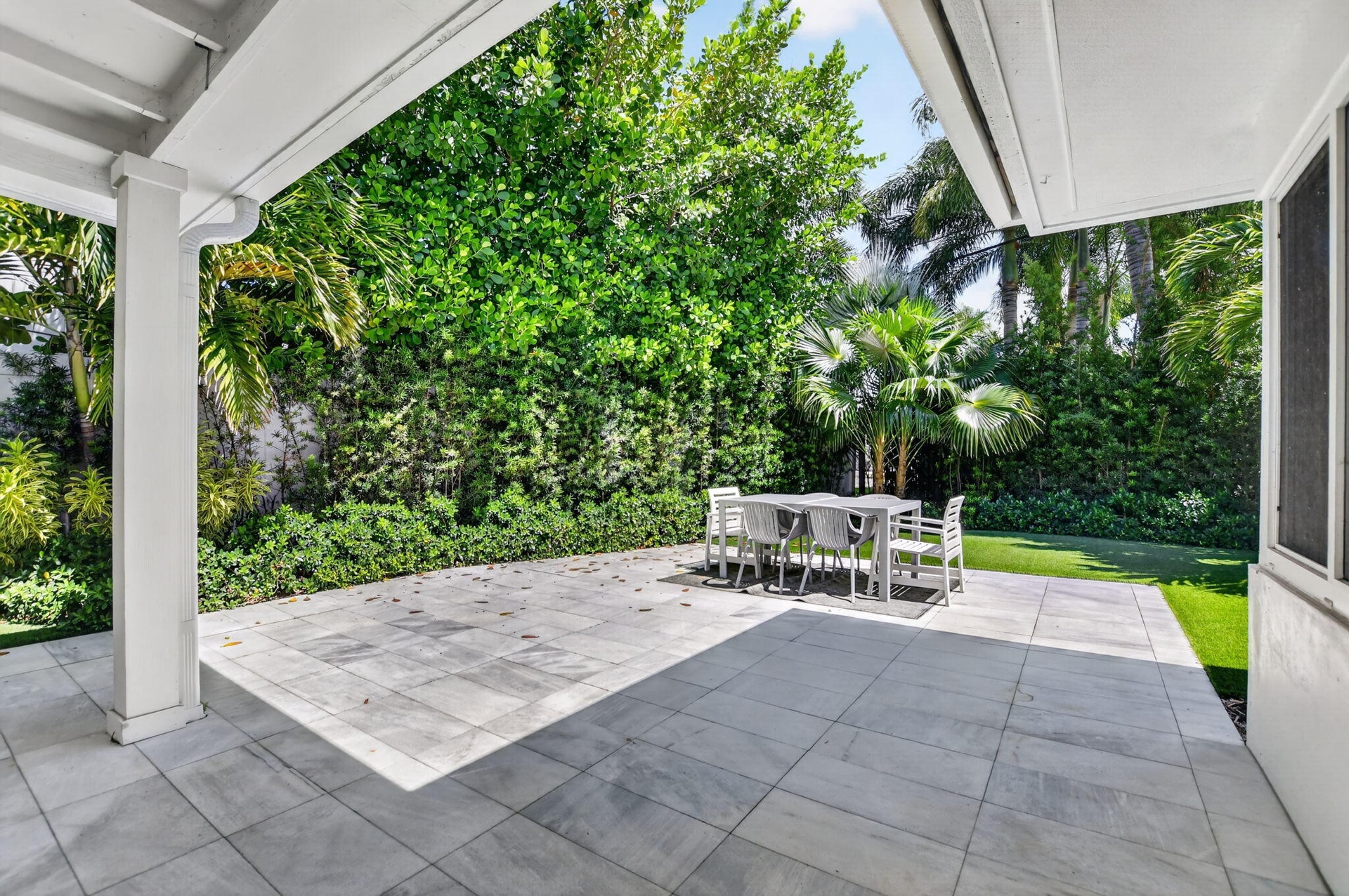 COVERED BACK PATIO area is perfect when you want to be in the shade or just out of the rain, This large newly installed patio area has the best of bot