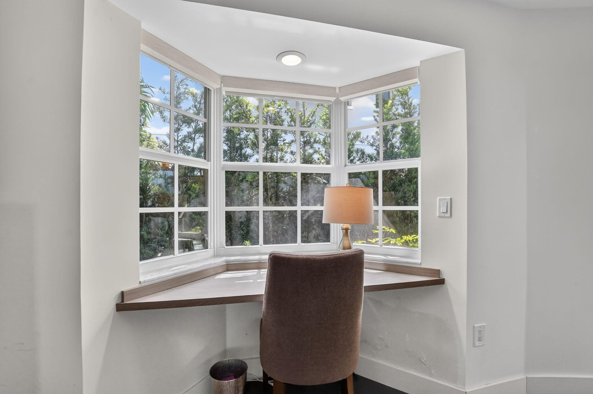 PRIMARY BEDROOM: This sunny Bay window offers a built-in desktop. Just bring your laptop, journal, morning to-do list and don't forget your morning co
