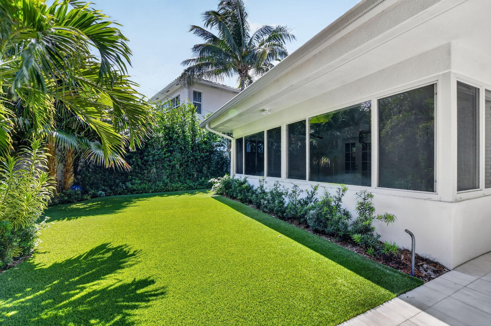 PRIVATE BACK YARD: This wall of new windows in the Sunroom offers a peaceful, calming view of this truly EVER-green very private oasis in the back yar