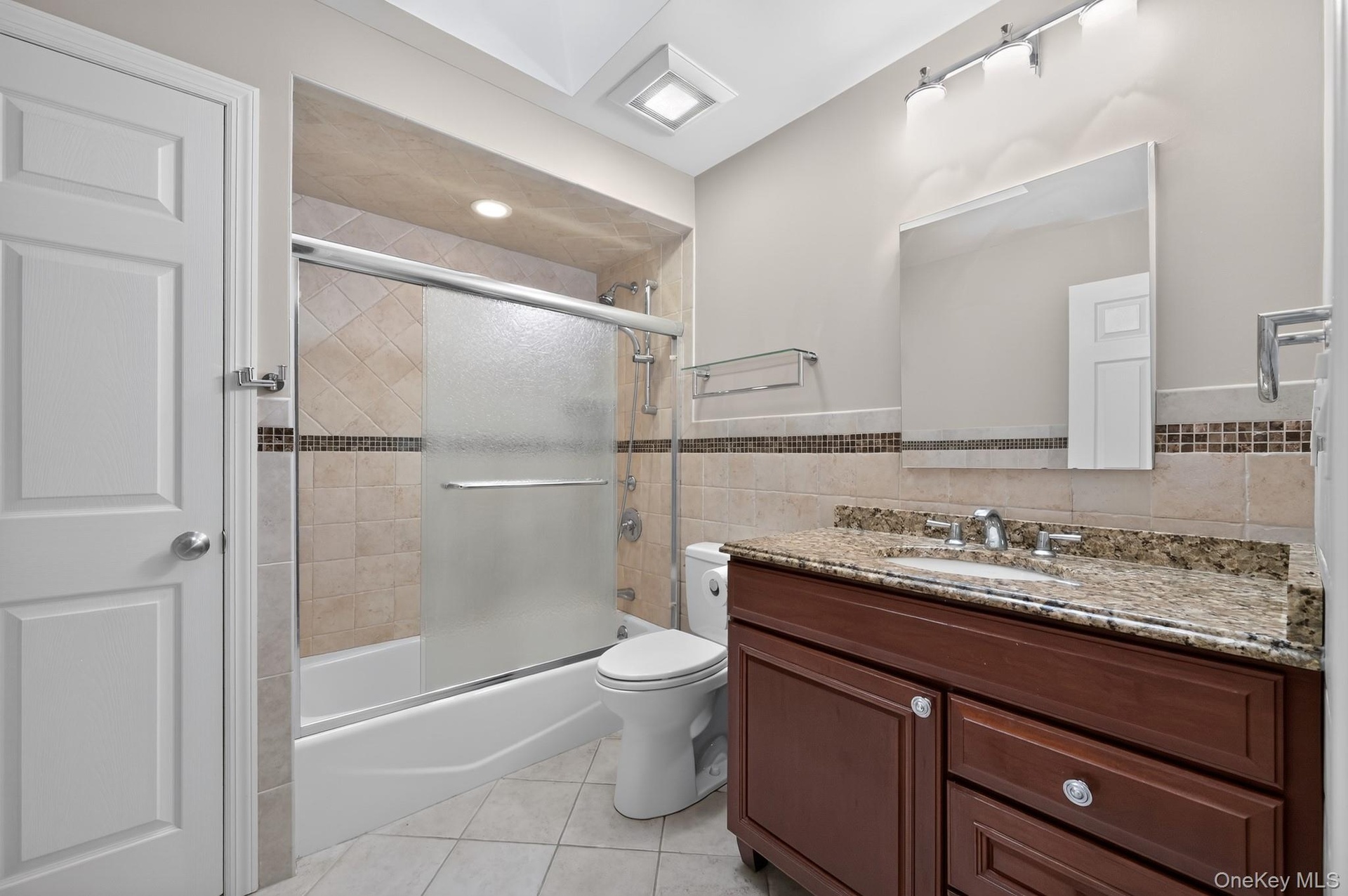 Newly Renovated Hallway Bathroom With Custom Tile and Soaking Tub