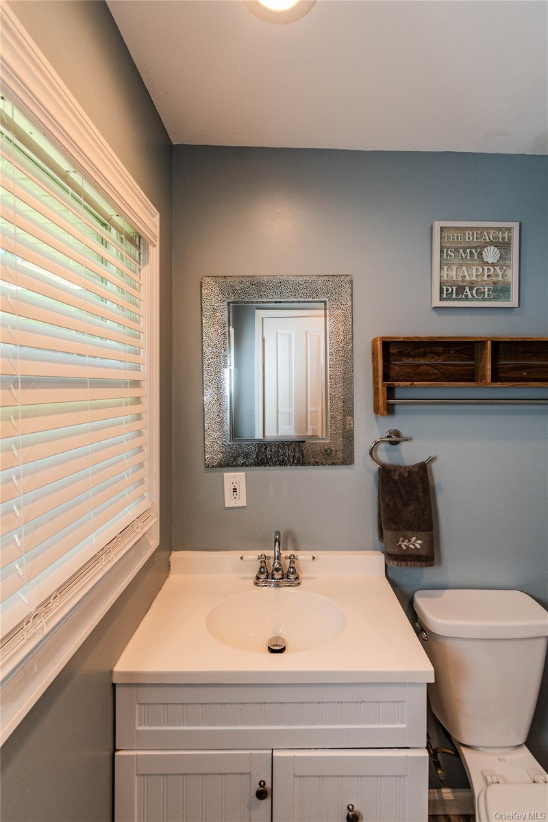 White vanity with integrated sink, and polished chrome faucet