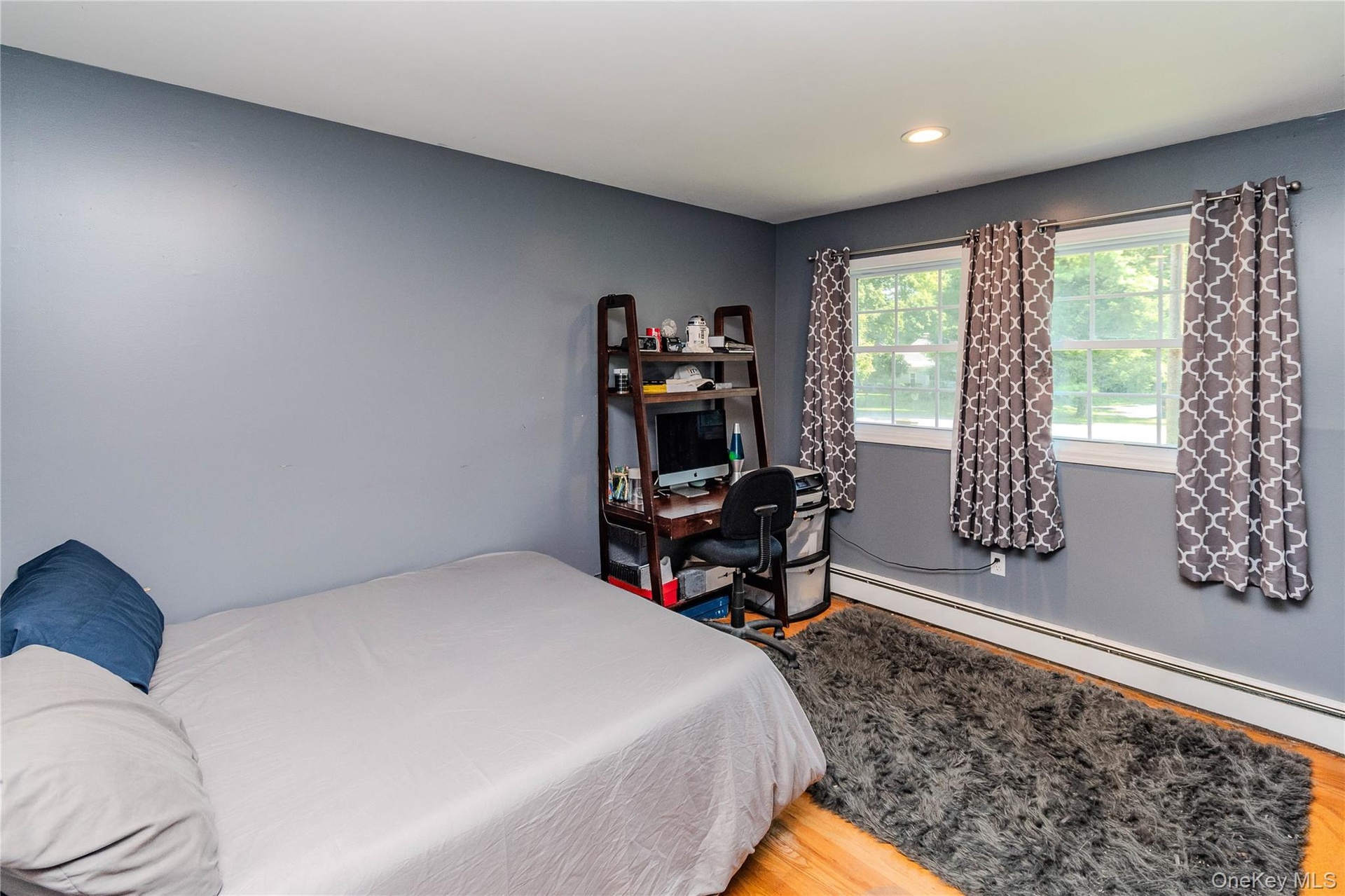Bedroom 2 Hardwood flooring, painted walls, recessed lighting, and dual windows