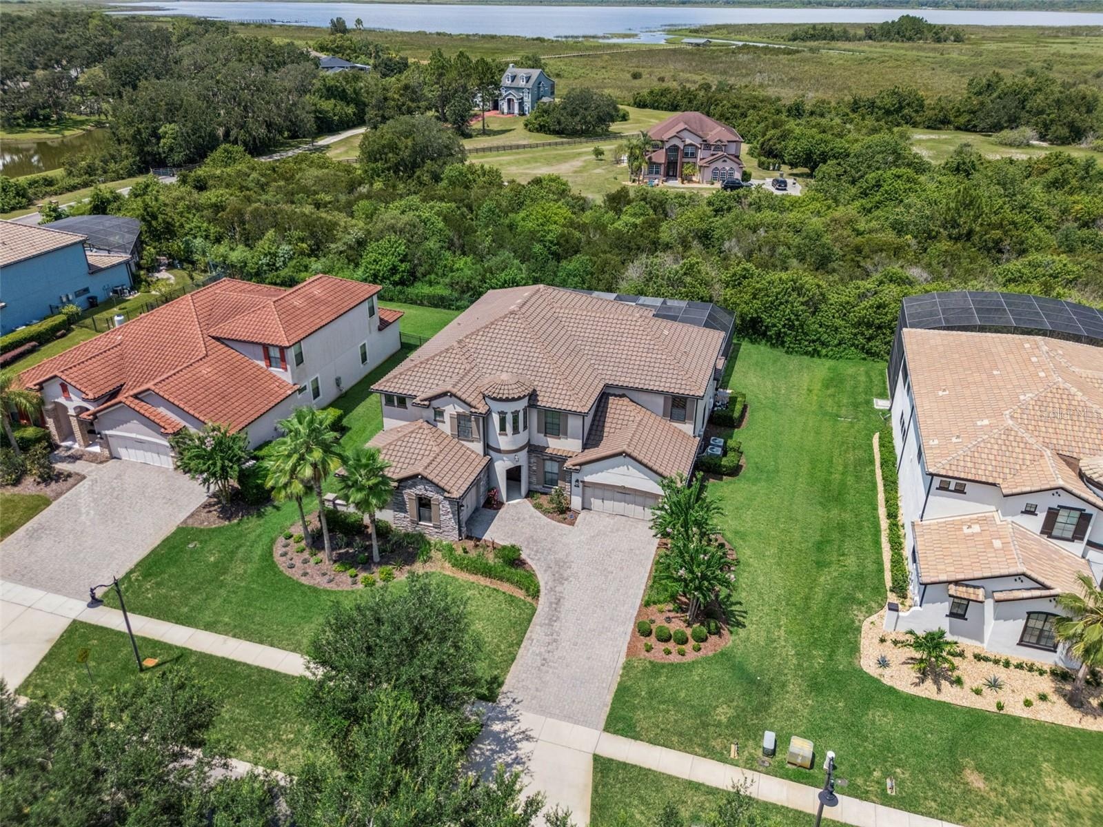 Luxury, privacy and LAKE ACCESS define this exceptional 6-bedroom, 5.5-bath CUSTOM POOL HOME in Waterside Vista, an intimate GATED ENCLAVE of just 24 