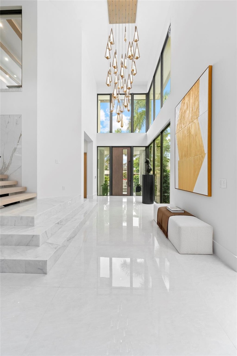 As you enter the home, you’re greeted by soaring open ceilings and a stunning foyer chandelier that sets the tone for the elegance found throughout th