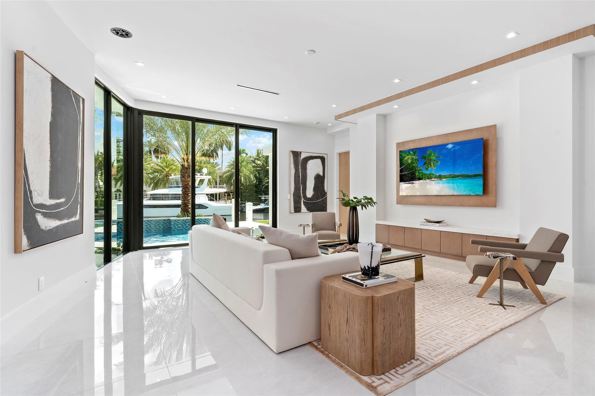 creating the perfect setting for relaxed living and effortless entertaining. Expansive glass doors fill the space with natural light and open to the o