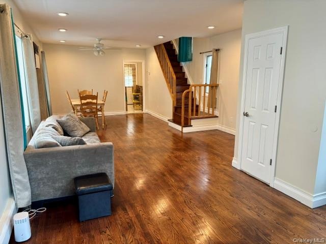 Hardwood flooring, recessed lighting, ceiling fan, and a wood staircase with wood balusters