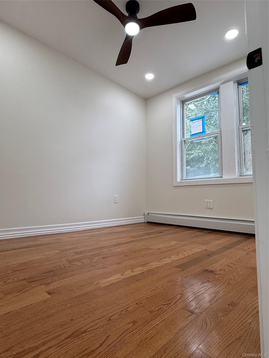 Hardwood flooring, recessed lighting, ceiling fan, and window