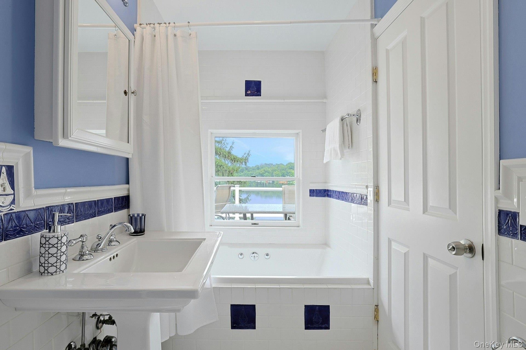 The adjoining bath also has an entrance from the hall and serves the third bedroom across the hall, with serene lake views, bringing beauty and a sens