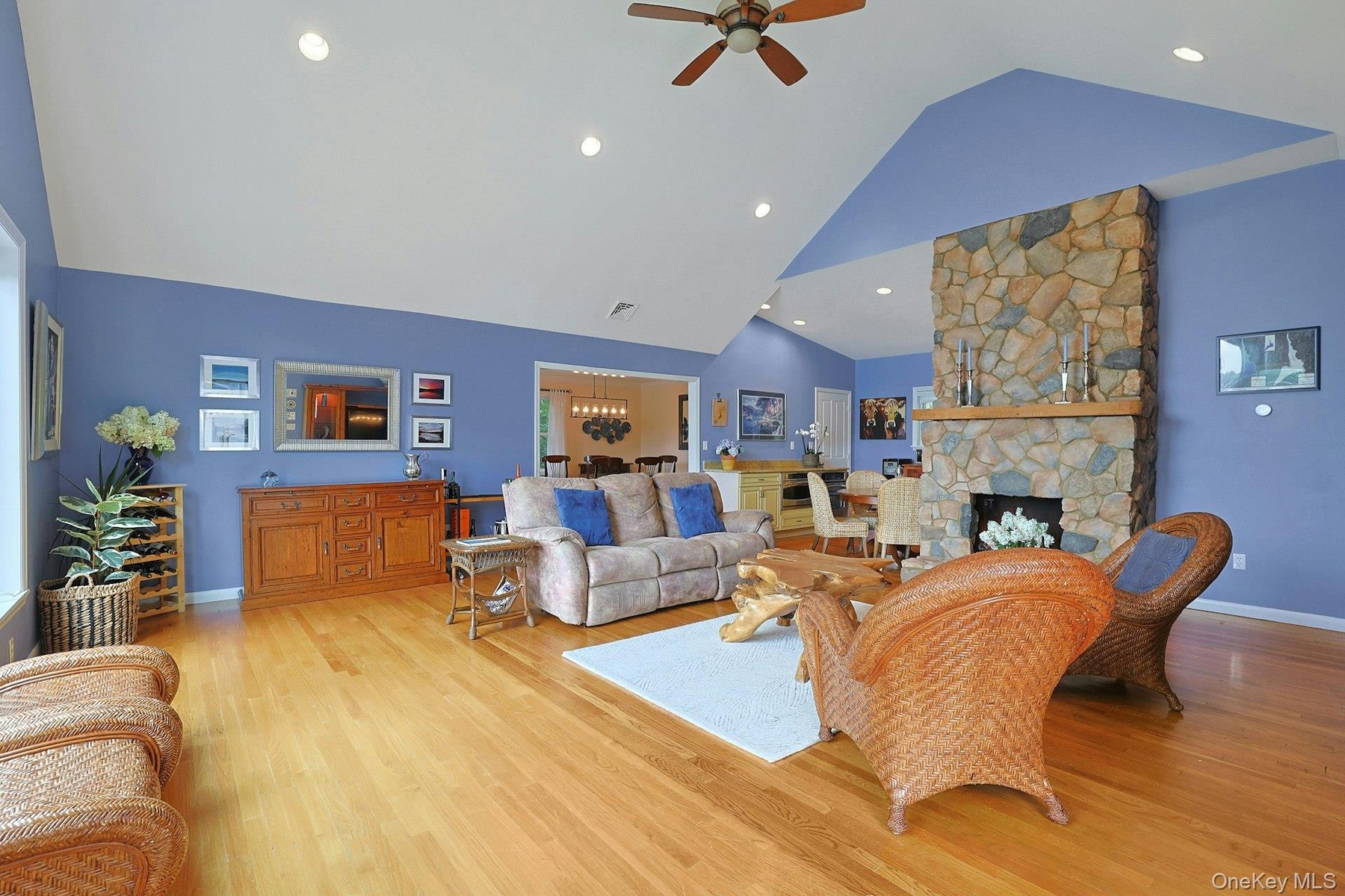 The spacious and inviting living room features a stunning stone fireplace. Pour yourself a drink at the bar, cozy up to the fireplace on autumn and wi