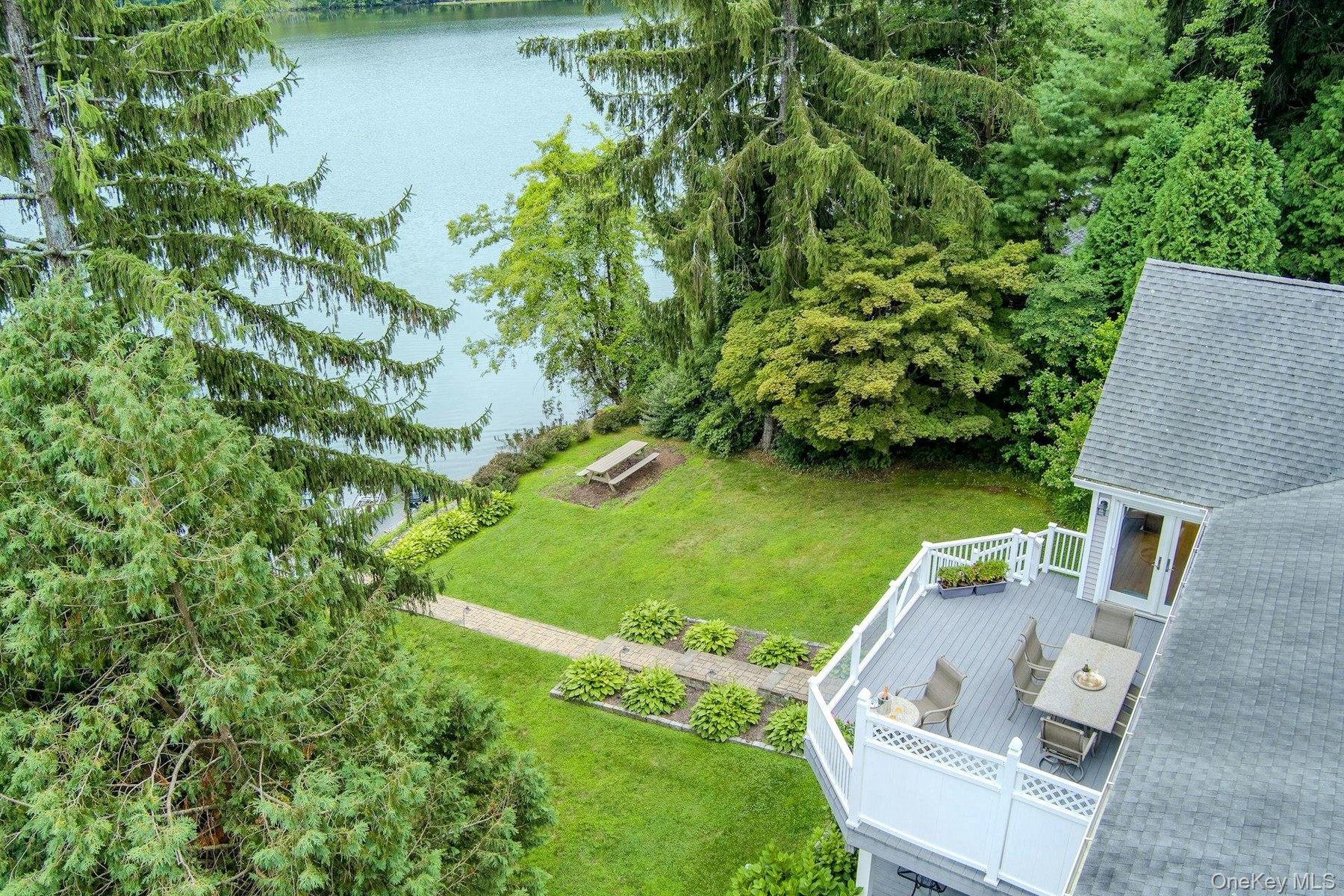 An aerial perspective highlights the expansive deck and short walk to the lake