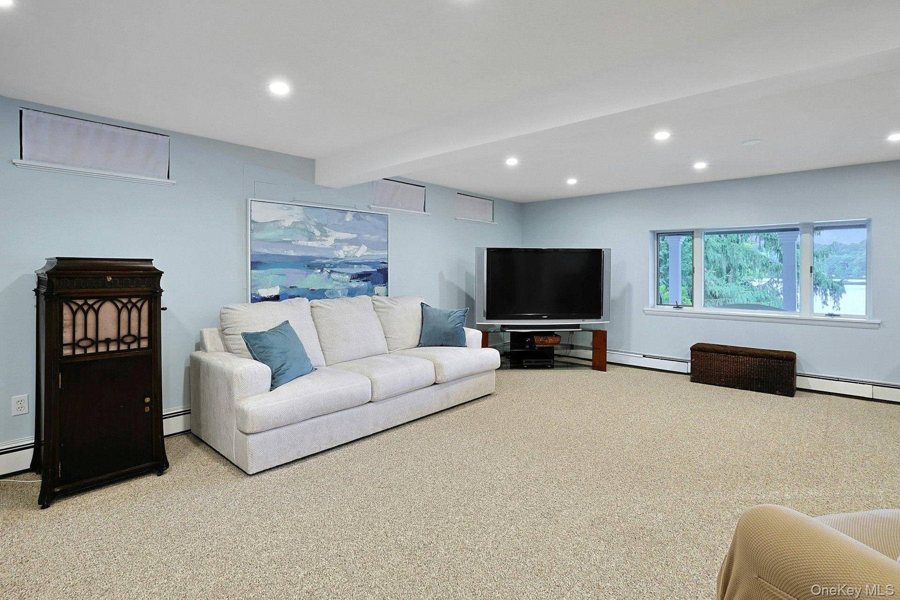 On the lower level, the spacious family room also offers beautiful lake views, creating the perfect place to relax, gather, and enjoy the scenery.