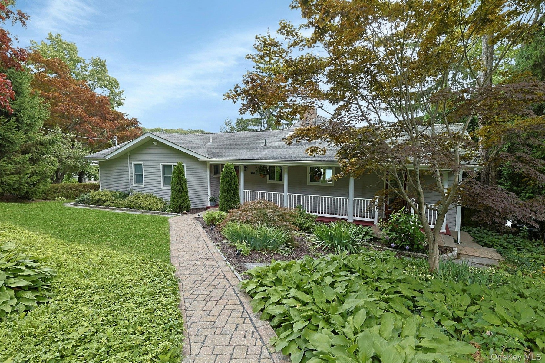 A welcoming walkway leads to your lake life dreams come true. With blooming perennials  offering beautiful curb appeal and a warm first impression, it