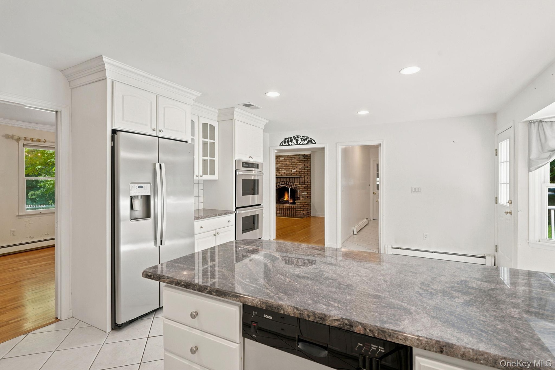 This view shows access to dining room and family room and the the hallway to right of family room entrance is location of powder room, laundry area an