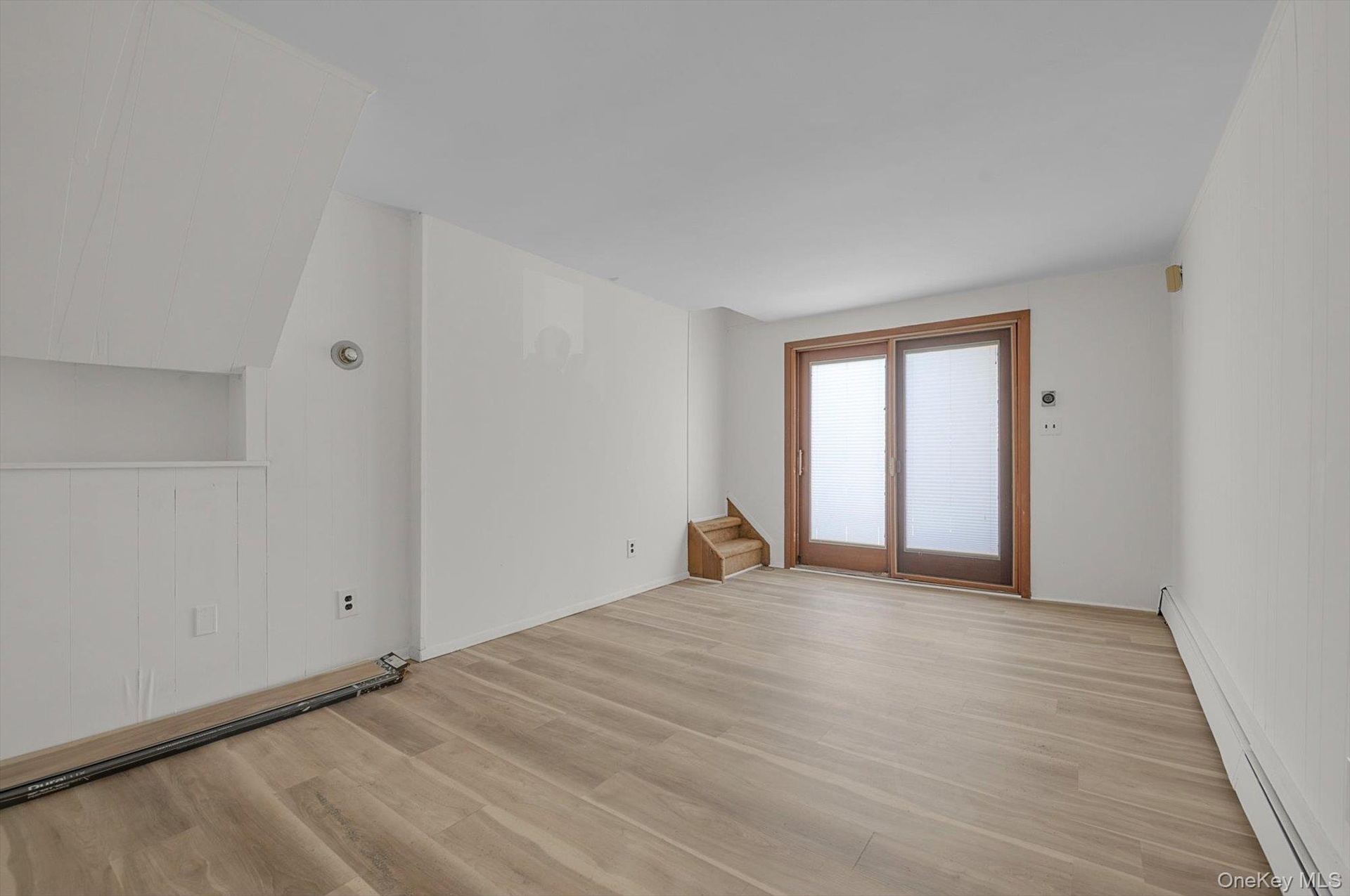 Large room with outside exit to backyard