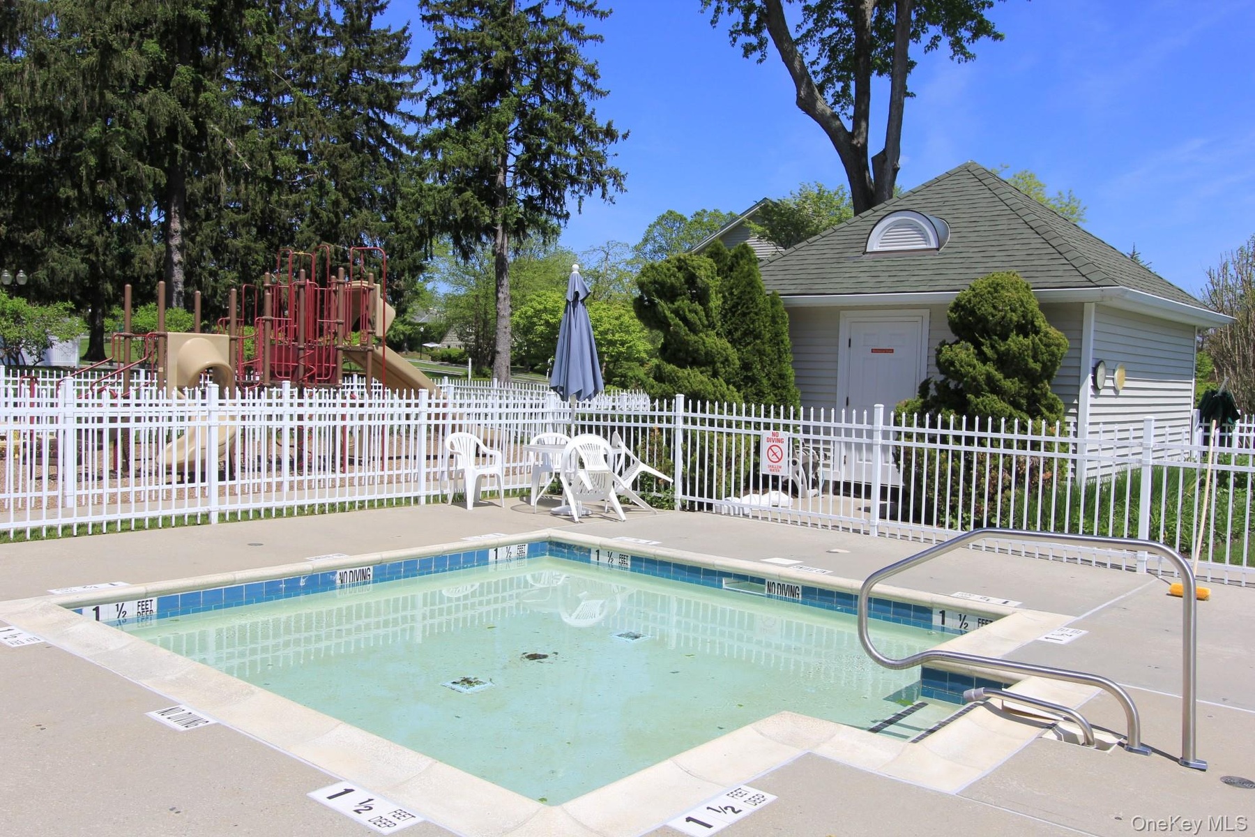 View of swimming pool with a playground and a patio area