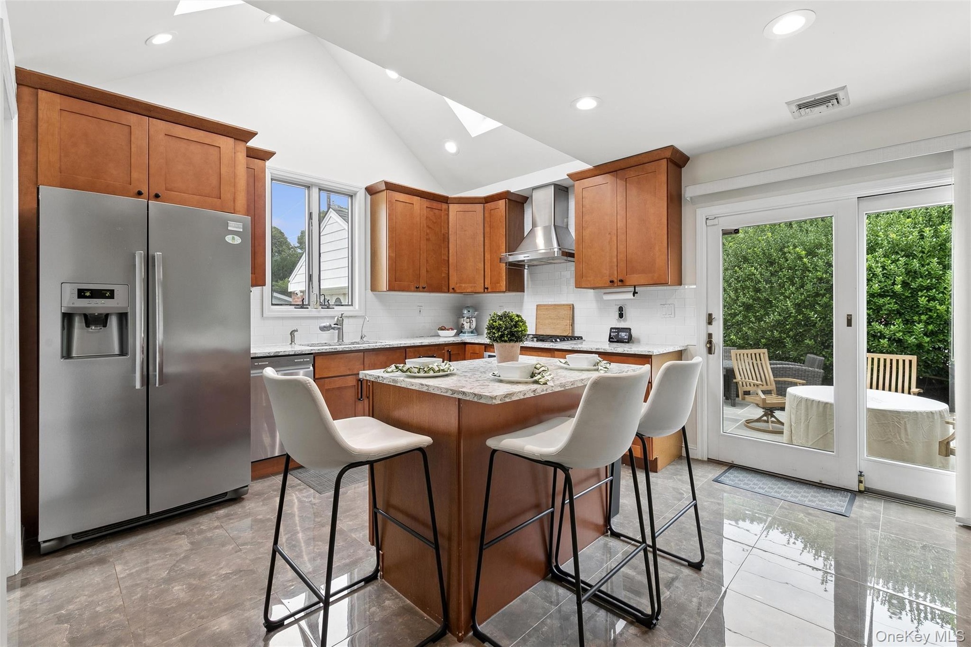 Fabulous eat-in-kitchen with vaulted, skylit ceiling and sliders to the patio