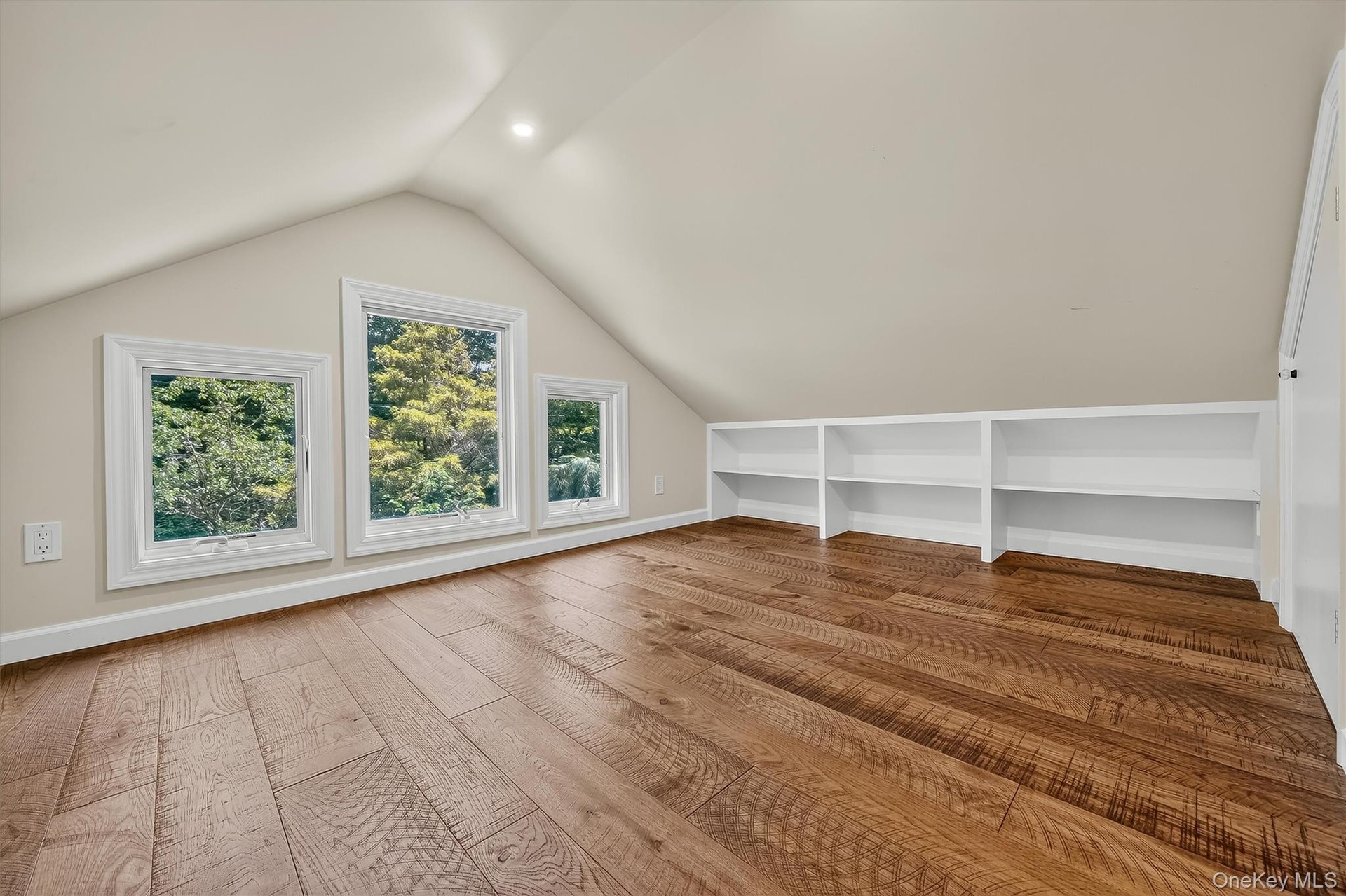 Hardwood-finish flooring, built-in shelving, white trim windows, sloped ceiling, recessed lighting