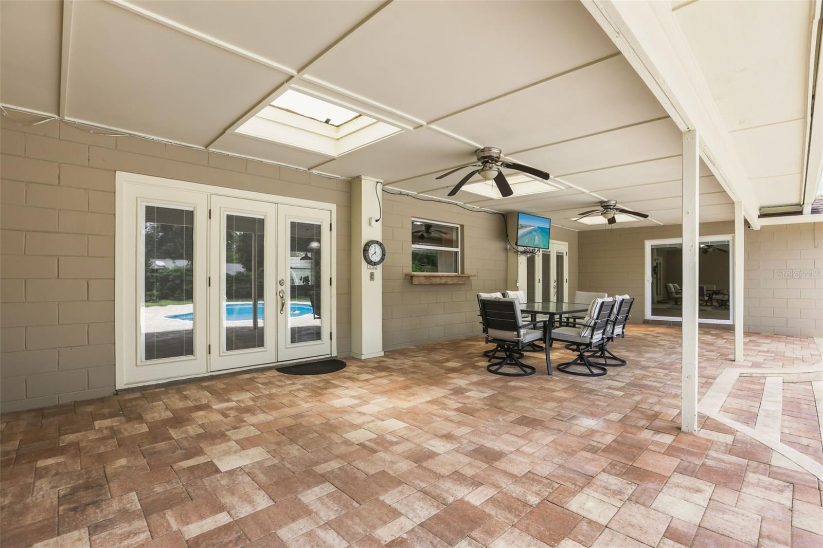 Step outside and discover your own PRIVATE OASIS where a  brick paver patio surrounds a sparkling in-ground pool, creating the perfect place to soak u
