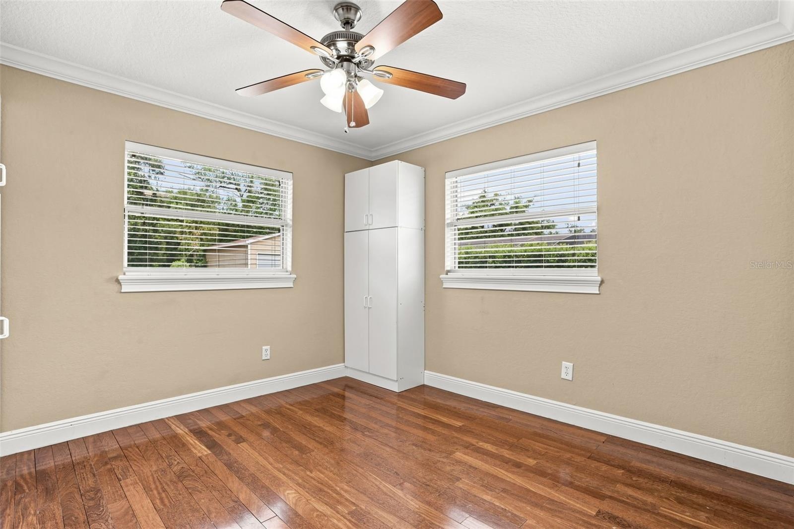 The fourth bedroom features BUILT-IN CABINETRY, making it an ideal home office or creative workspace.