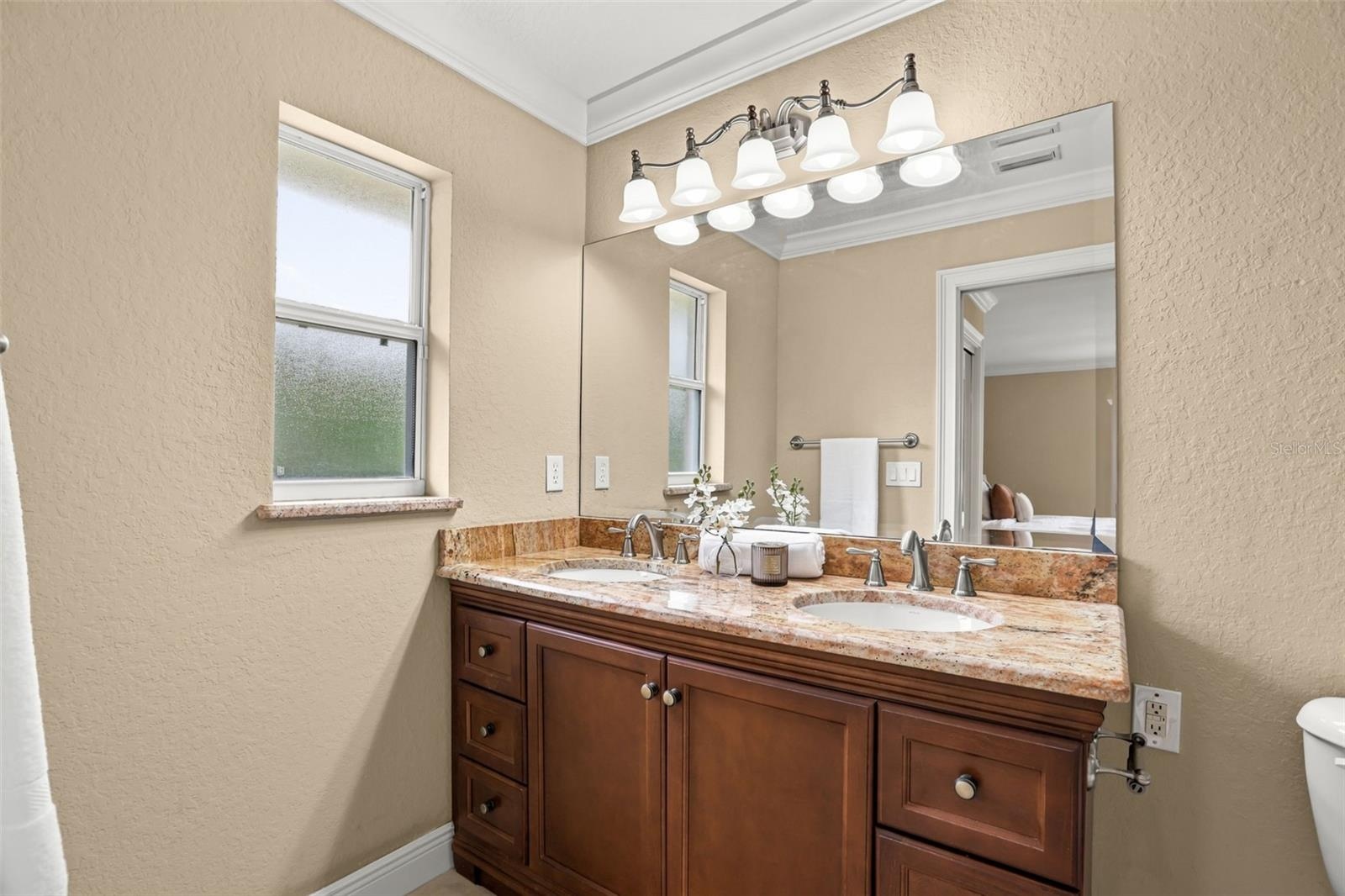 The Primary EN SUITE BATH features dual sinks and a large tiled walk-in shower.