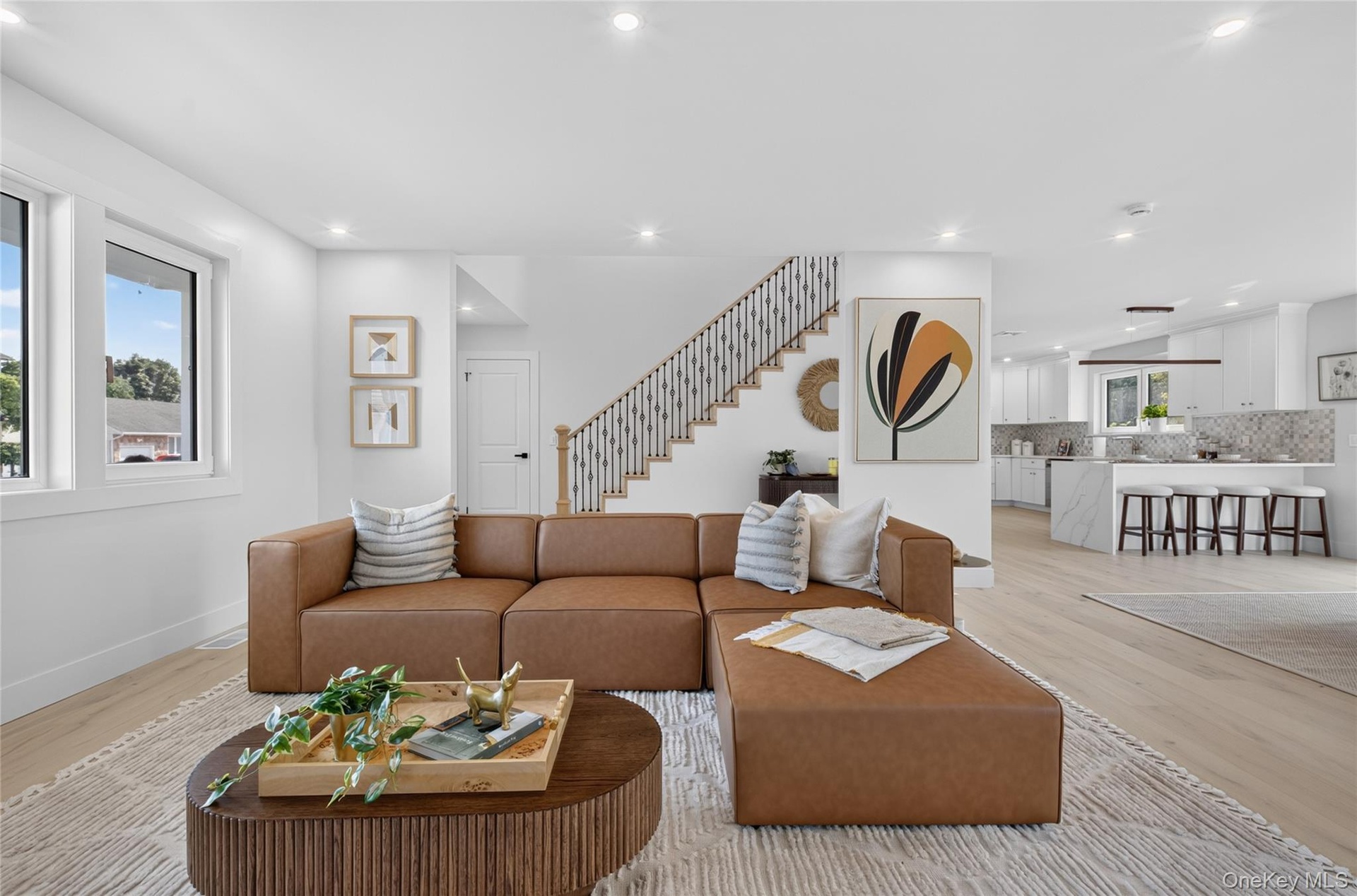 Open concept living area featuring light wood-finish flooring