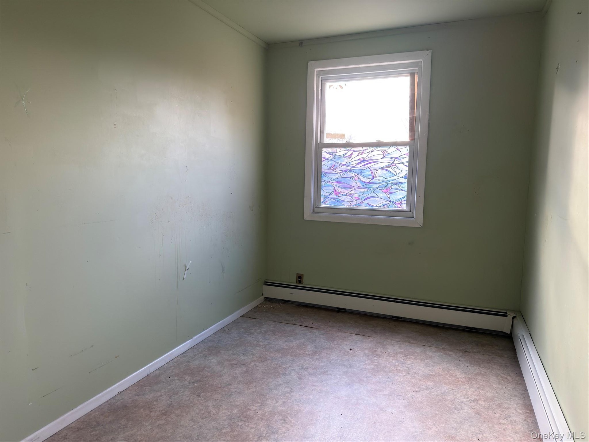 Unfurnished room with a baseboard radiator