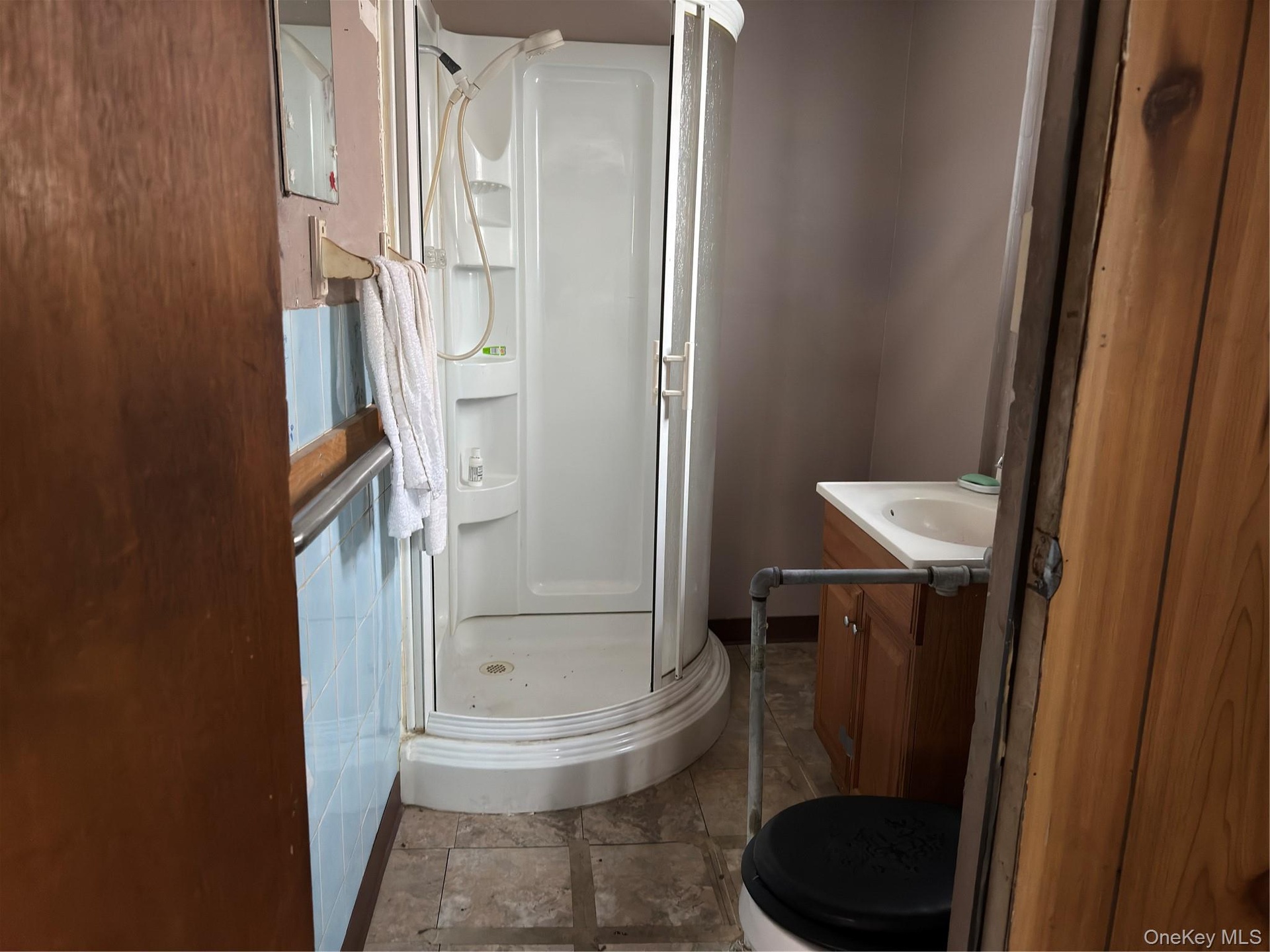 Bathroom with vanity and a stall shower