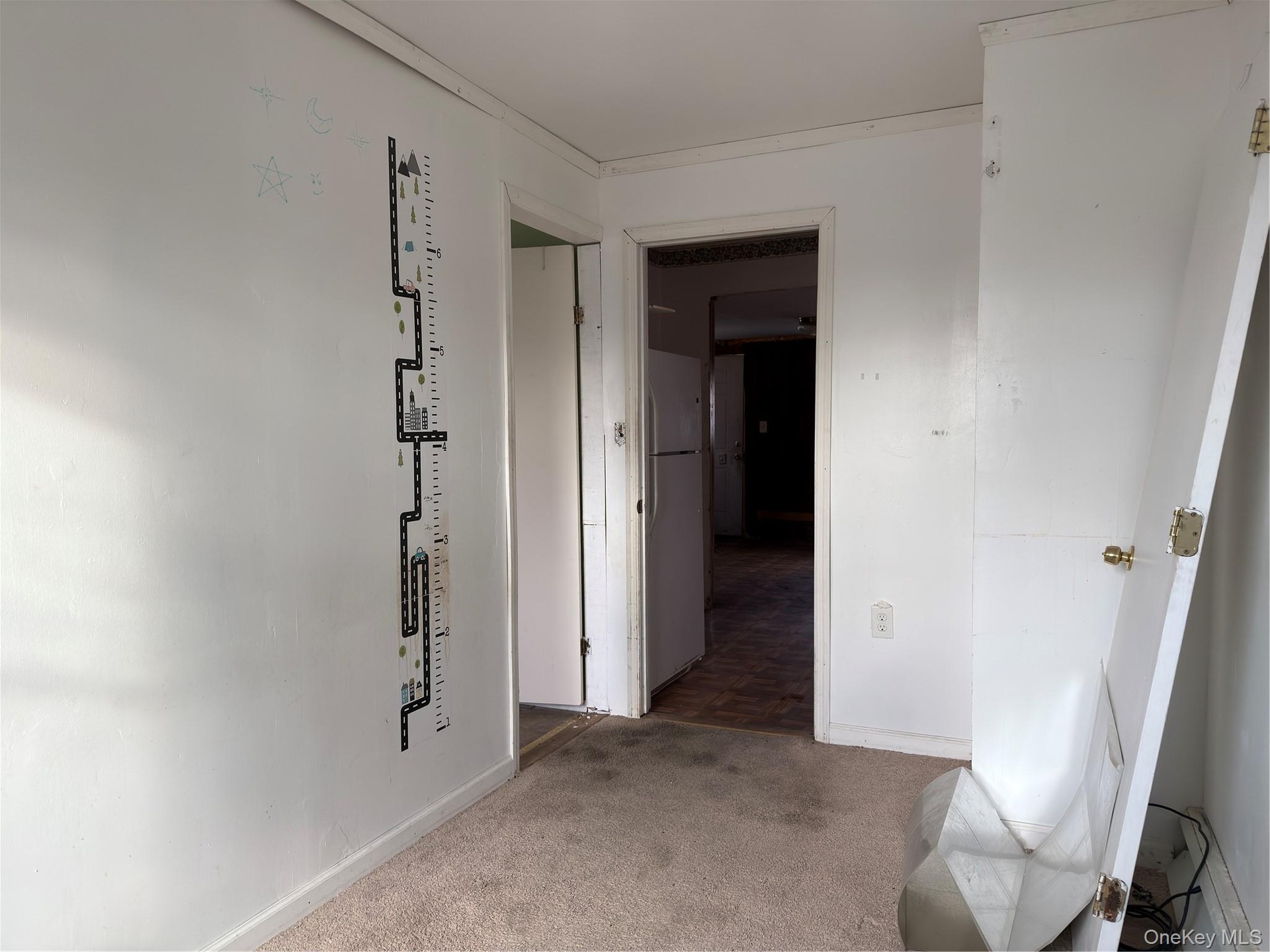 Hall featuring carpet floors and baseboards