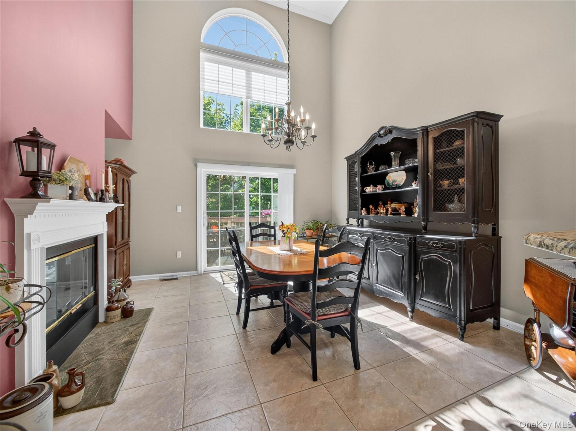 Stunning open-plan formal dining room with approx 20'+ ceiling, arched window, slider to the private deck.